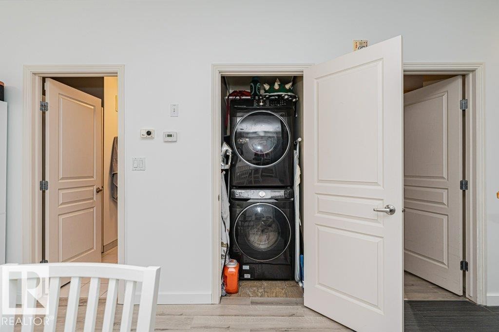 Laundry closet with stacked washer and dryer unit - #202 9503 101 Av Nw, Edmonton, AB