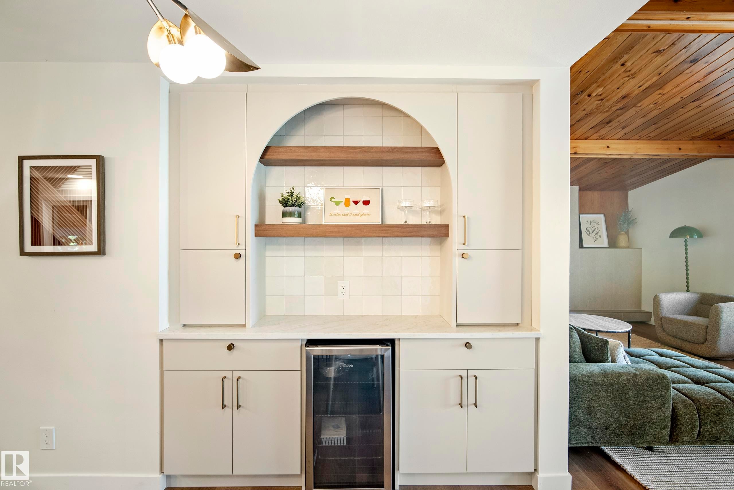 Built-in cabinetry featuring an arched display niche with wood-finish shelving, an integrated beverage cooler, and a tiled backsplash - 10316 42 Street Nw, Edmonton, AB