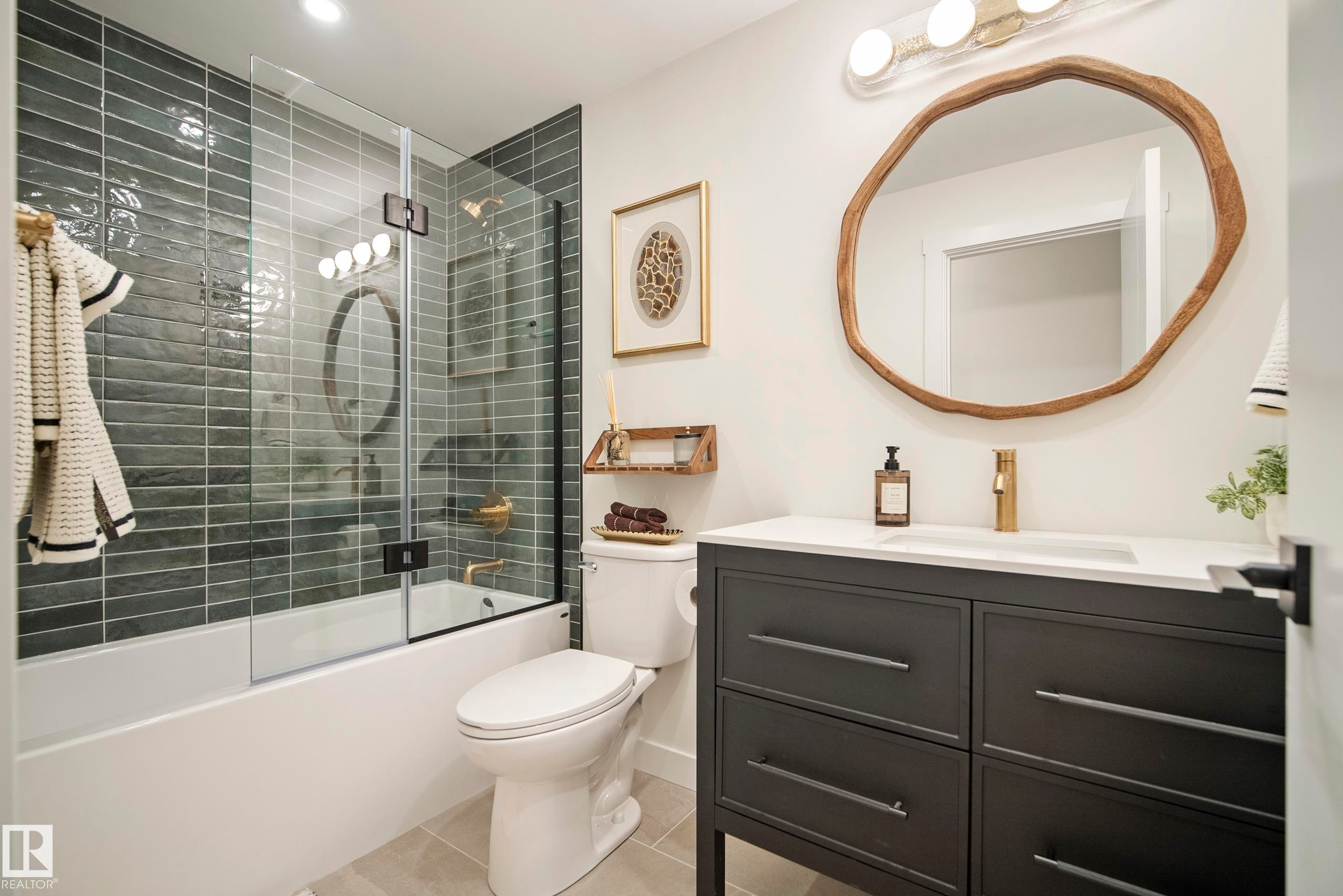 White bathtub with glass shower enclosure and dark gray horizontal tile - 10316 42 Street Nw, Edmonton, AB