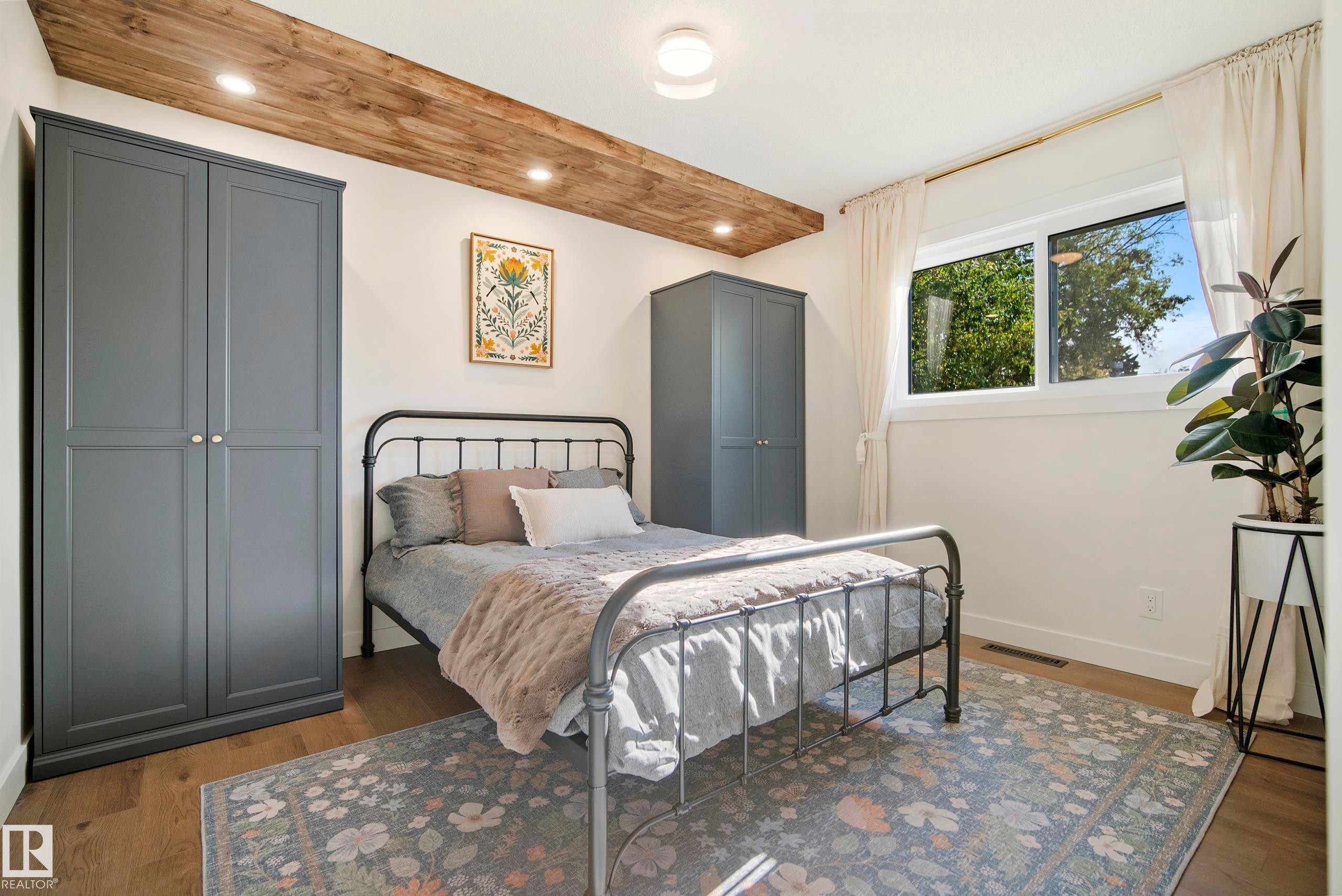 Wood-finish flooring, recessed lighting, and a white ceiling with a wood-clad beam - 10316 42 Street Nw, Edmonton, AB