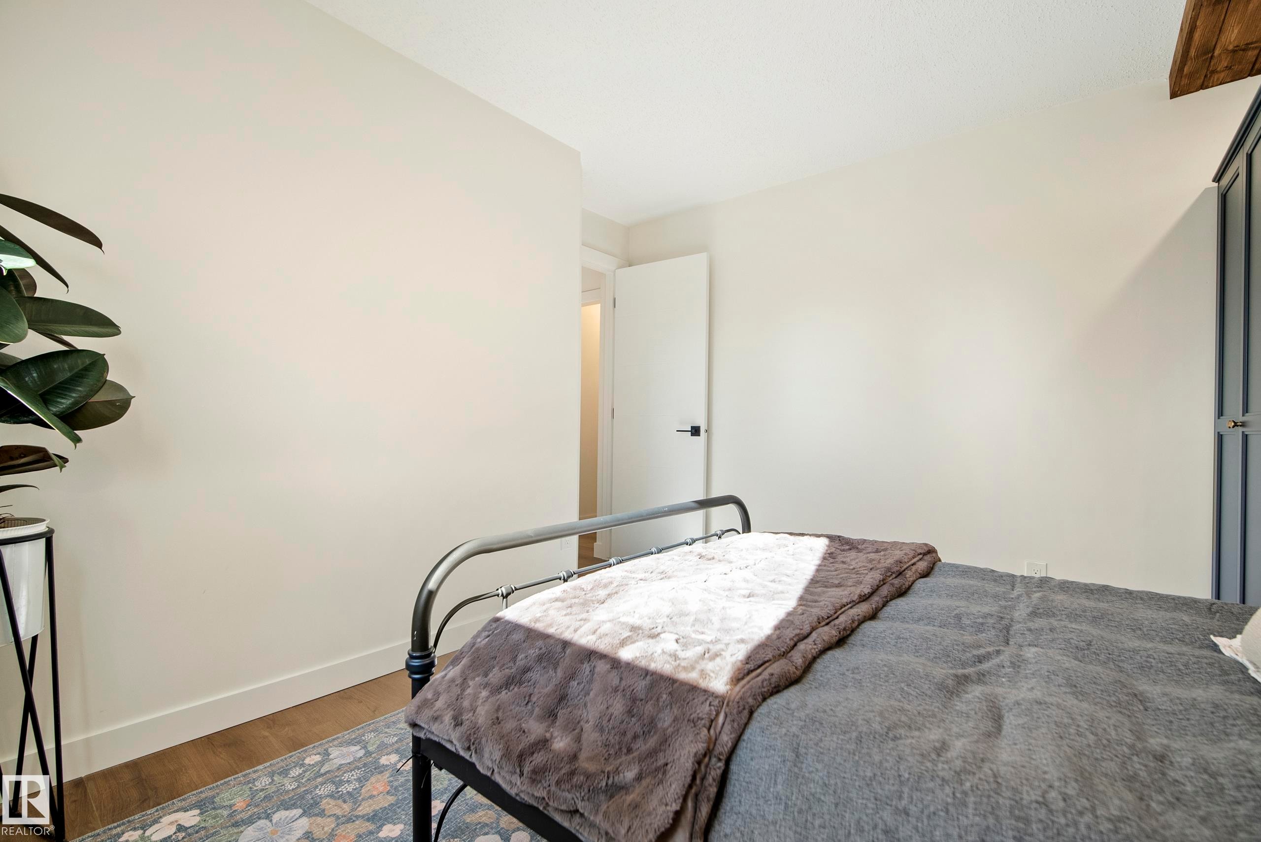 Wood-finish flooring with light-toned walls and a white ceiling - 10316 42 Street Nw, Edmonton, AB