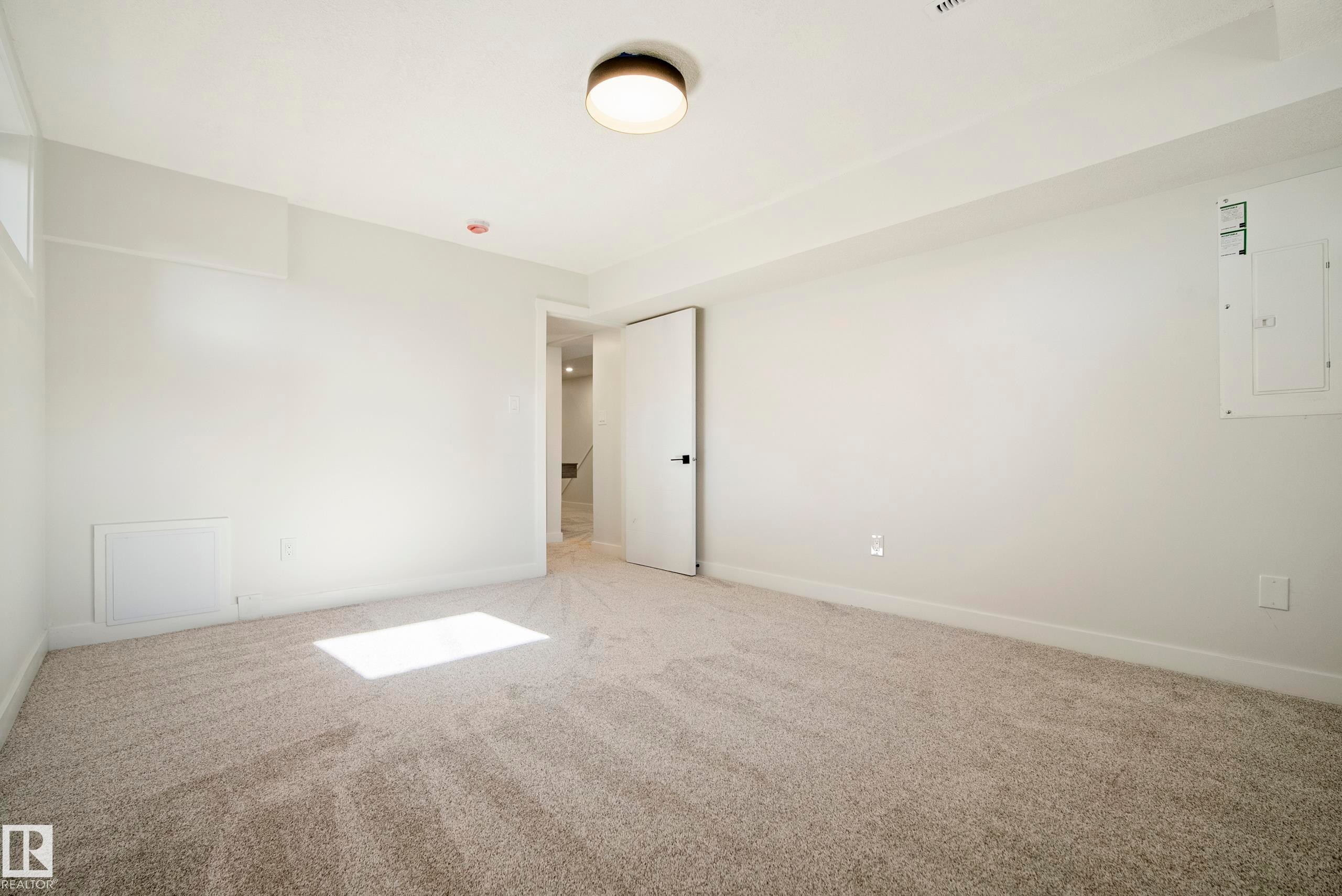 Recessed window, neutral wall paint, light-toned carpet, and a flush mount ceiling light - 10316 42 Street Nw, Edmonton, AB