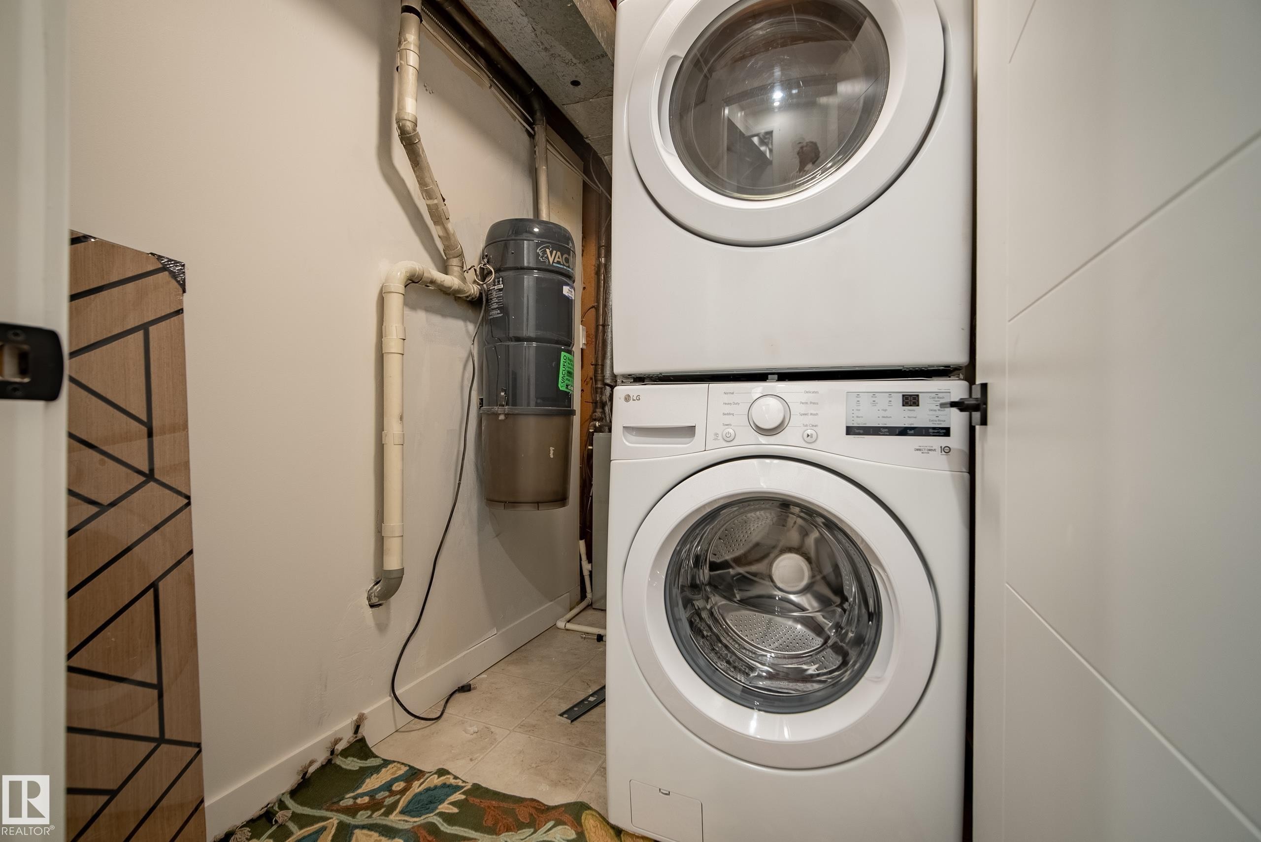 Stackable washer and dryer appliances within a dedicated utility area - 10316 42 Street Nw, Edmonton, AB