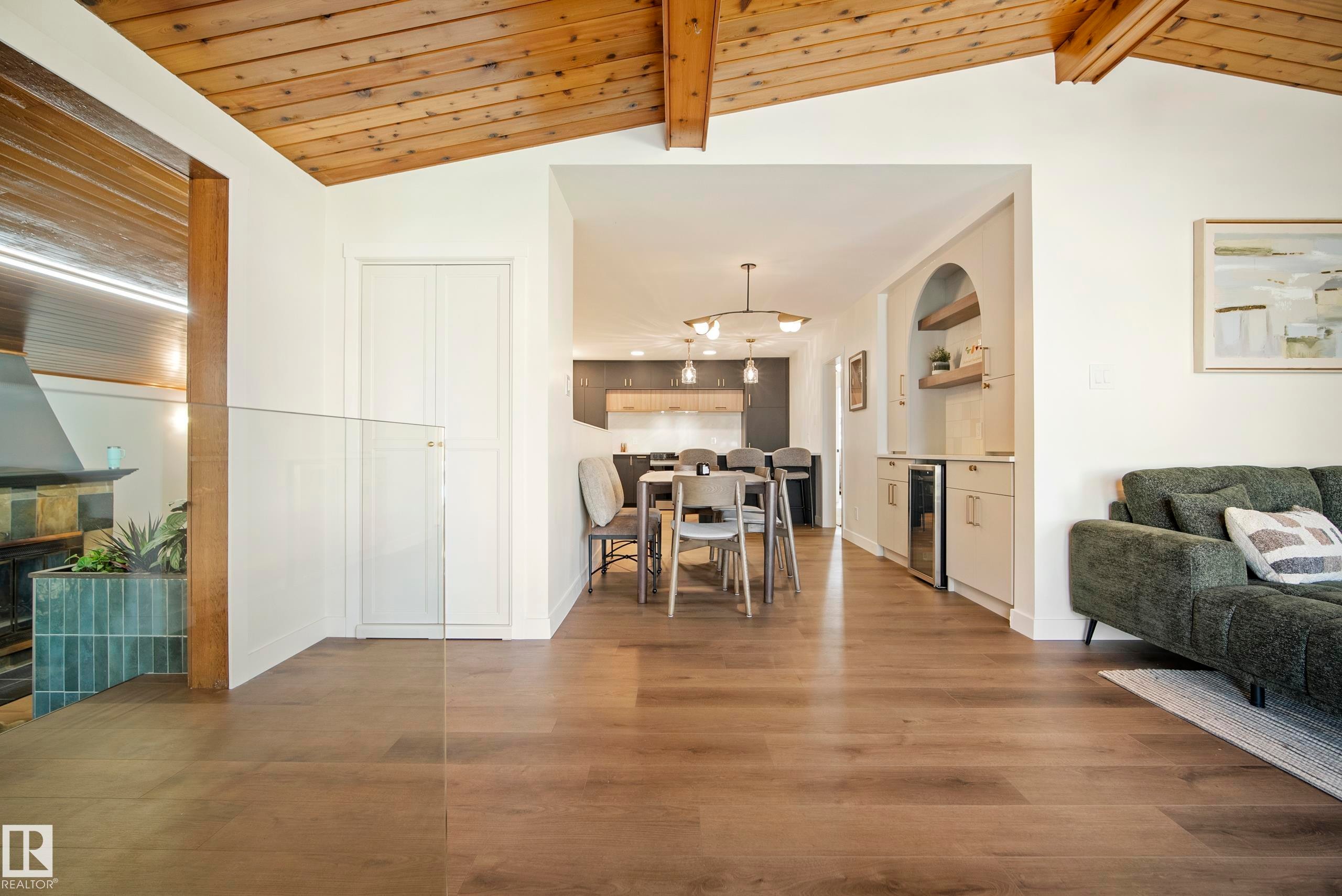 Vaulted wood-paneled ceilings, wood-finish flooring, built-in wet bar, and glass panel railing - 10316 42 Street Nw, Edmonton, AB