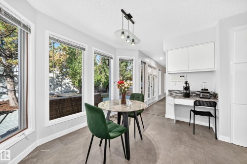 Large windows, tile flooring, built-in cabinetry, and double French doors - 5830 181 Street Nw, Edmonton, AB 