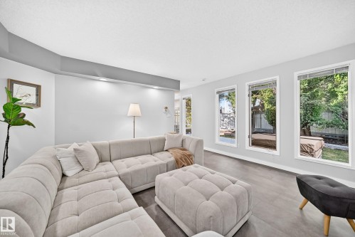 Recessed lighting, wood-finish flooring, multiple windows, and light gray wall paint - 5830 181 Street Nw, Edmonton, AB 
