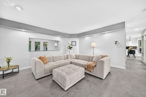 Recessed lighting, light gray wall tones, ceiling-mounted light fixtures, tile flooring, and a wide entryway - 5830 181 Street Nw, Edmonton, AB 