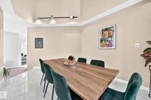 Vaulted ceiling with track lighting, light-toned walls, and tile flooring - 5830 181 Street Nw, Edmonton, AB 