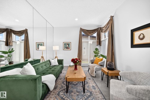 Full wall mirrored paneling, recessed lighting, expansive windows with custom drapery, and wood-finish flooring - 5830 181 Street Nw, Edmonton, AB 