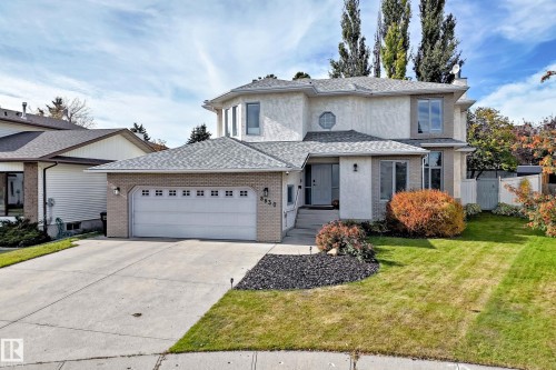 Stucco and brick exterior with a front-facing garage - 5830 181 Street Nw, Edmonton, AB 