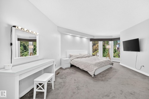 Carpeted flooring throughout, recessed lighting, and a bay window - 5830 181 Street Nw, Edmonton, AB 