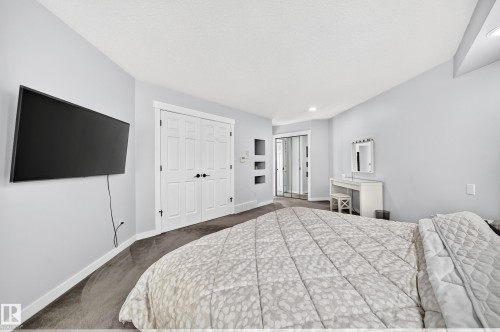 Built-in wall shelving, integrated ceiling lighting, and sliding mirror closet doors - 5830 181 Street Nw, Edmonton, AB 