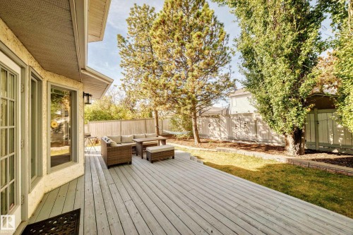Expansive wooden deck with a built-in bench, offering direct access to the interior - 5830 181 Street Nw, Edmonton, AB 
