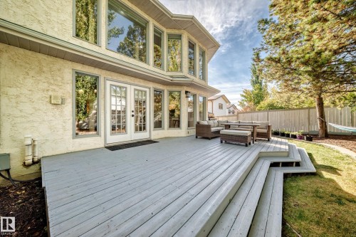 Expansive deck with multi-level steps, direct access via double French doors, large bay windows, and stucco exterior - 5830 181 Street Nw, Edmonton, AB 