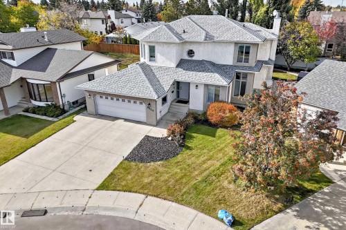 Stucco exterior with multi-pane windows and an attached two-car garage - 5830 181 Street Nw, Edmonton, AB 