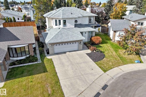 Two-story residence featuring a two-car garage, concrete driveway, and stucco exterior - 5830 181 Street Nw, Edmonton, AB 