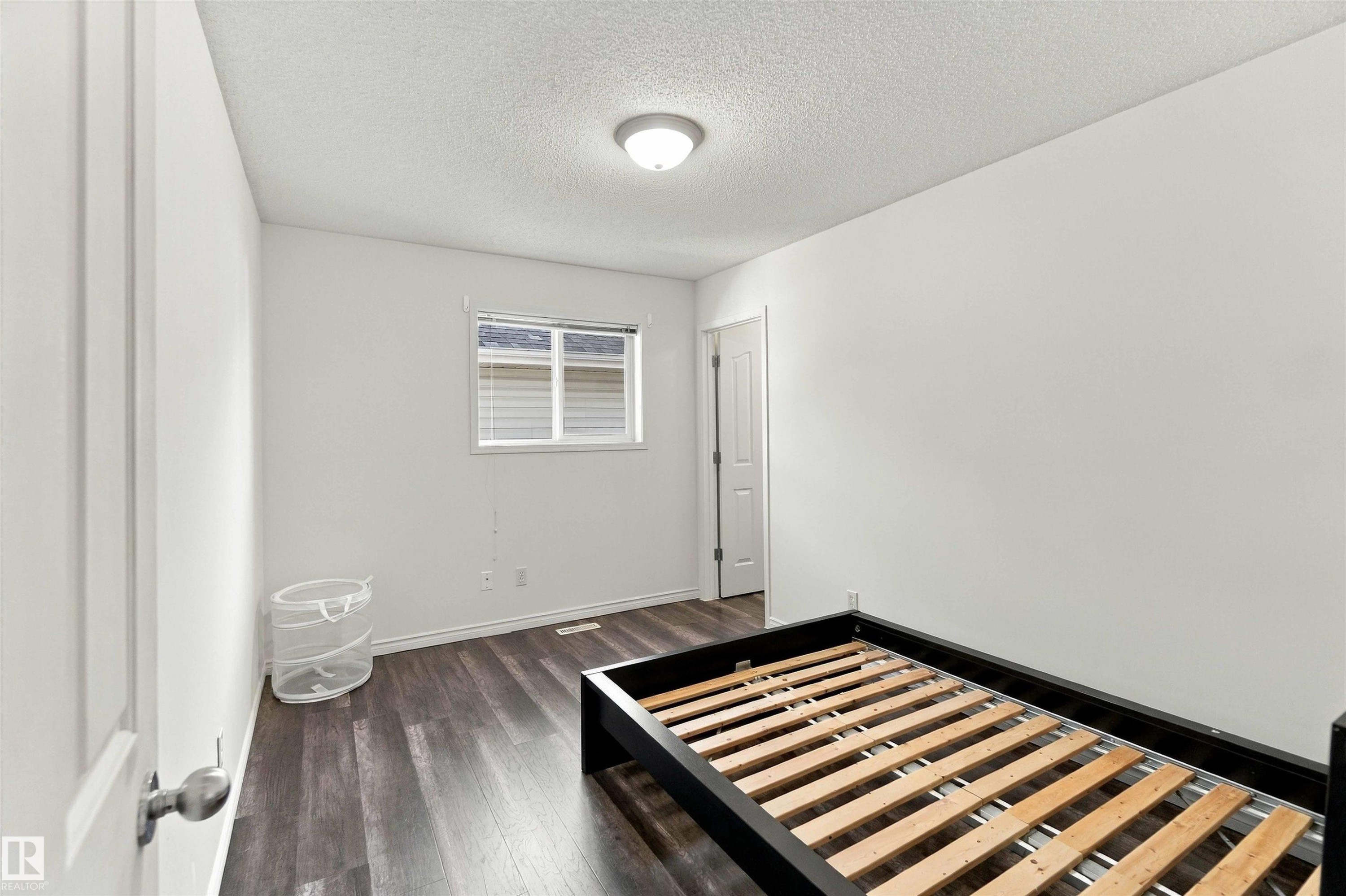 Wood-finish flooring, white walls, and a window with blinds - 3524 Mclean Crescent Sw, Edmonton, AB
