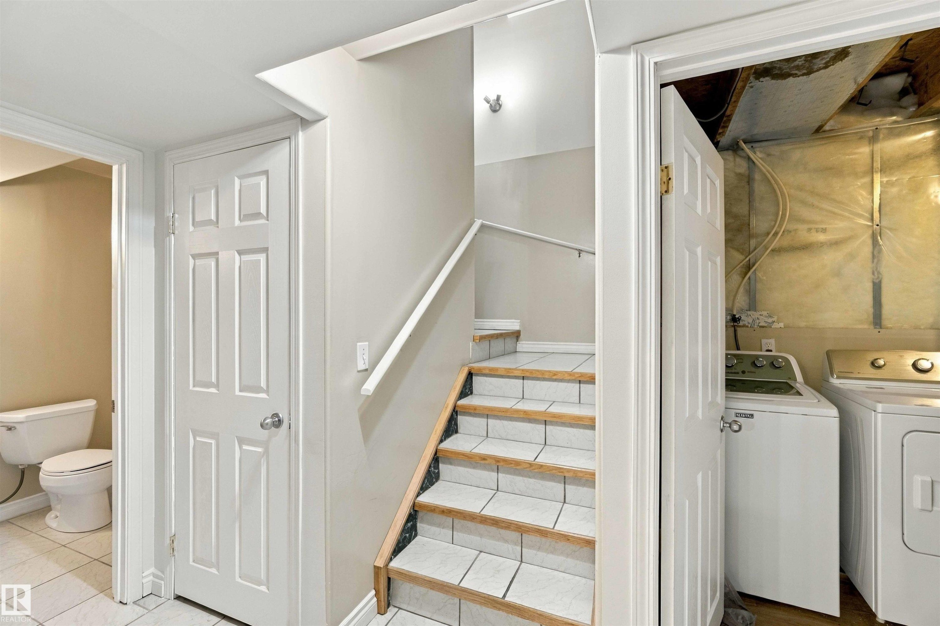 Tile flooring, white paneled doors, and a staircase with wood-finish treads - 3524 Mclean Crescent Sw, Edmonton, AB
