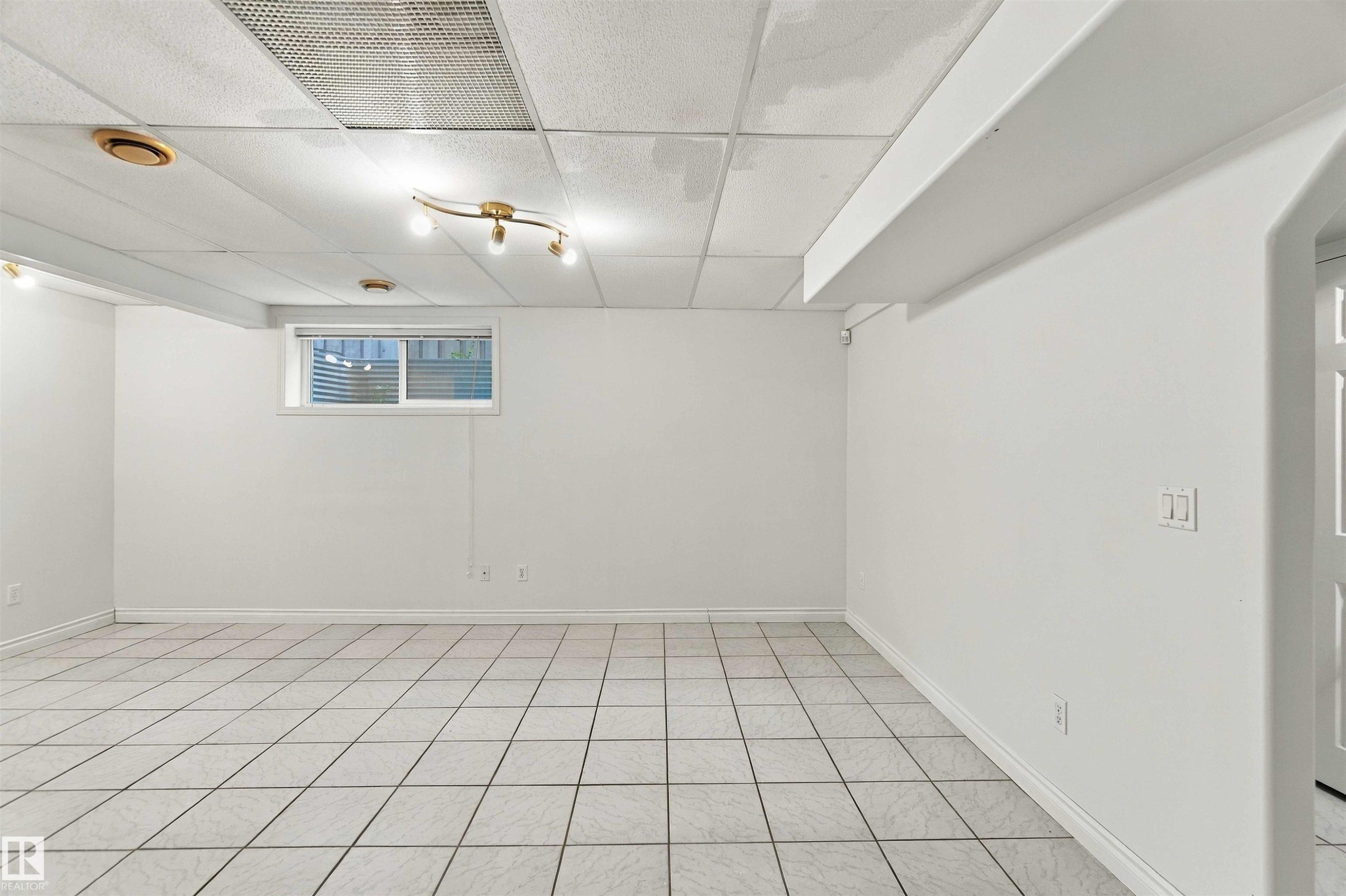 White tile flooring, track lighting, recessed lighting, white walls, and a window with horizontal blinds - 3524 Mclean Crescent Sw, Edmonton, AB