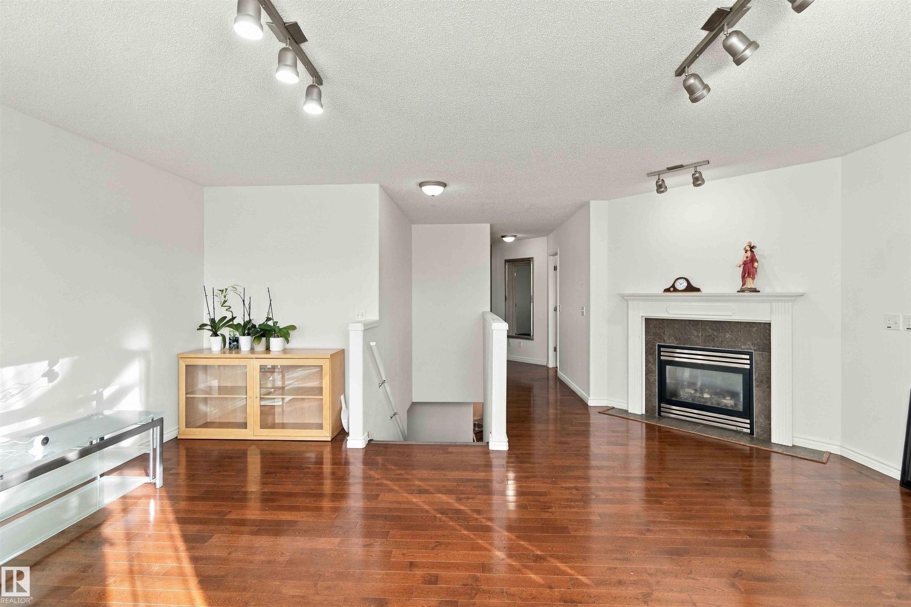 Warm wood-finish flooring complements the interior space - 3524 Mclean Crescent Sw, Edmonton, AB