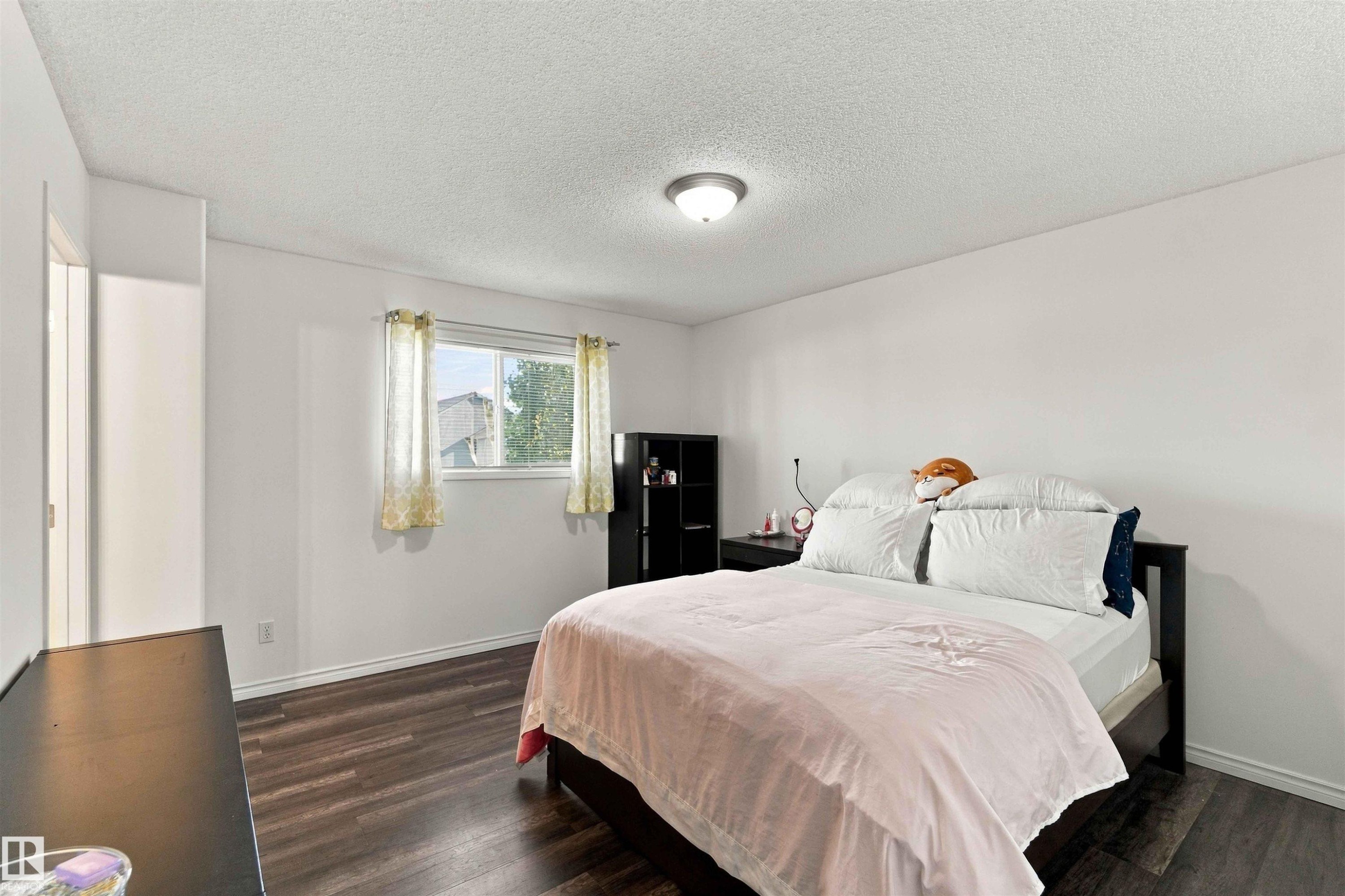 Wood-finish flooring, white walls, and a window with trim - 3524 Mclean Crescent Sw, Edmonton, AB