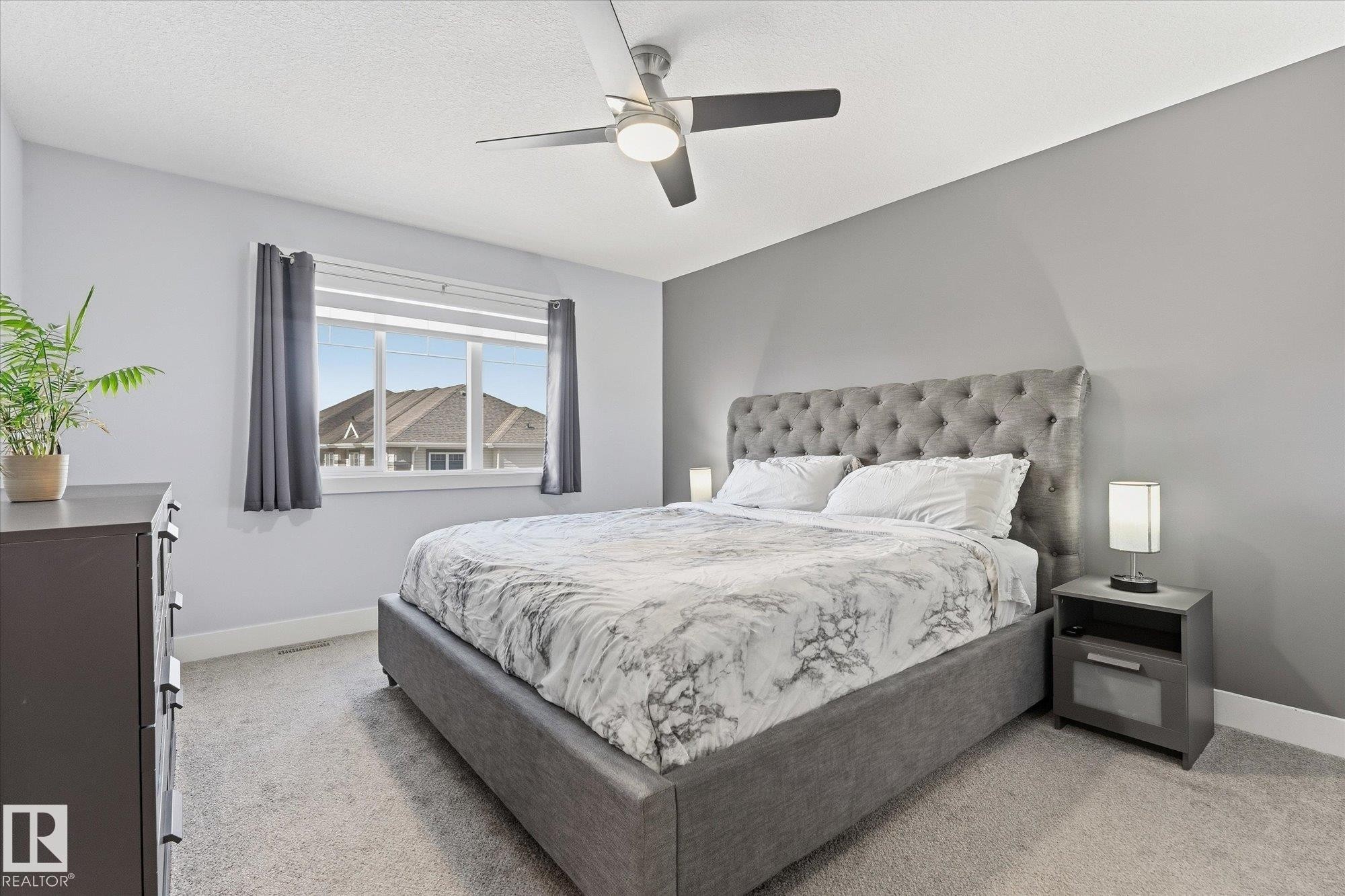 Light gray wall color, white window trim, and a ceiling fan with integrated lighting - #15 4835 Wright Dr Sw, Edmonton, AB
