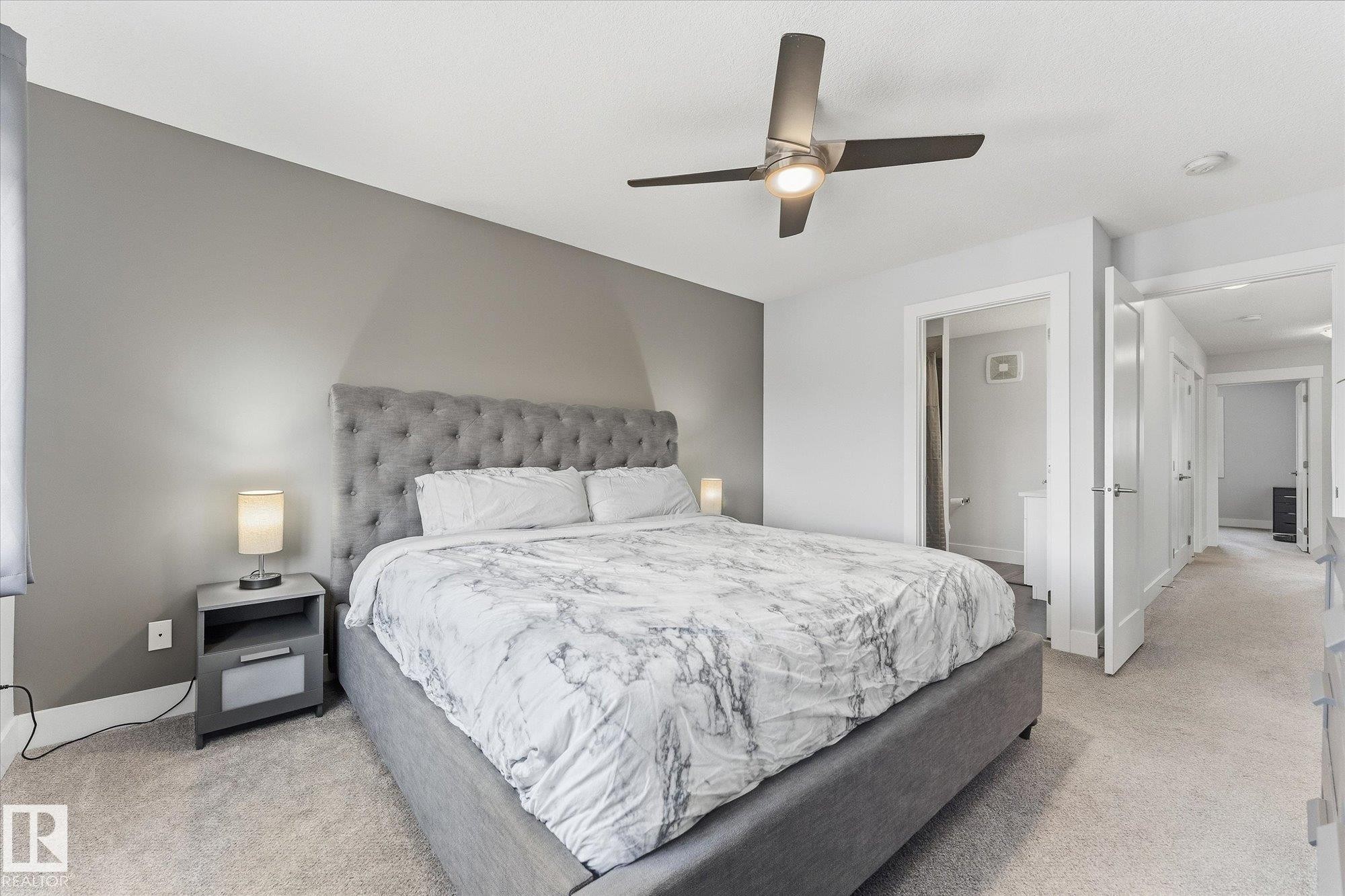 Neutral wall paint, ceiling fan with integrated lighting, light-toned carpet flooring, white trim and interior doors - #15 4835 Wright Dr Sw, Edmonton, AB