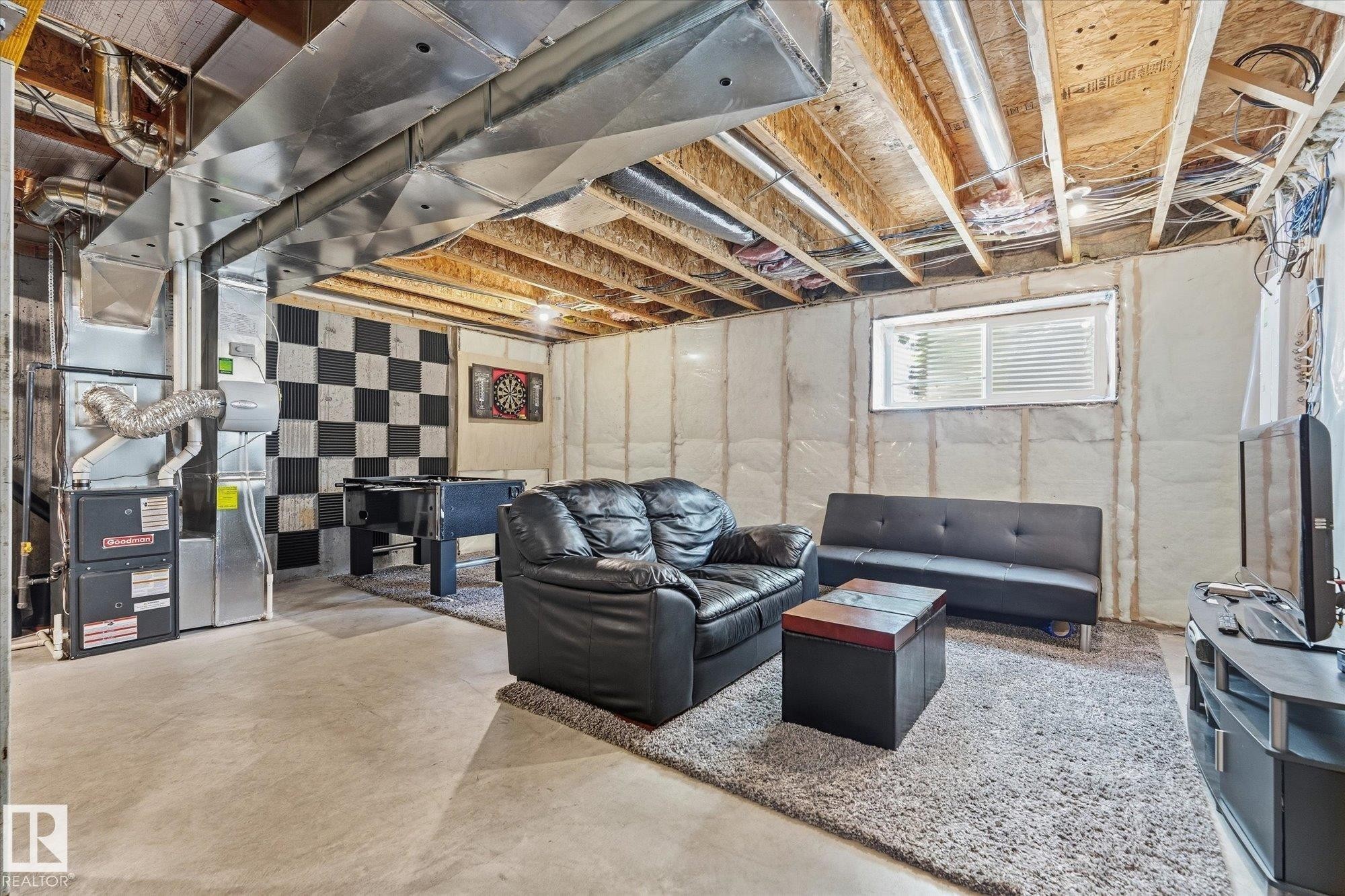 Unfinished basement space with exposed ceiling joists and concrete flooring - #15 4835 Wright Dr Sw, Edmonton, AB
