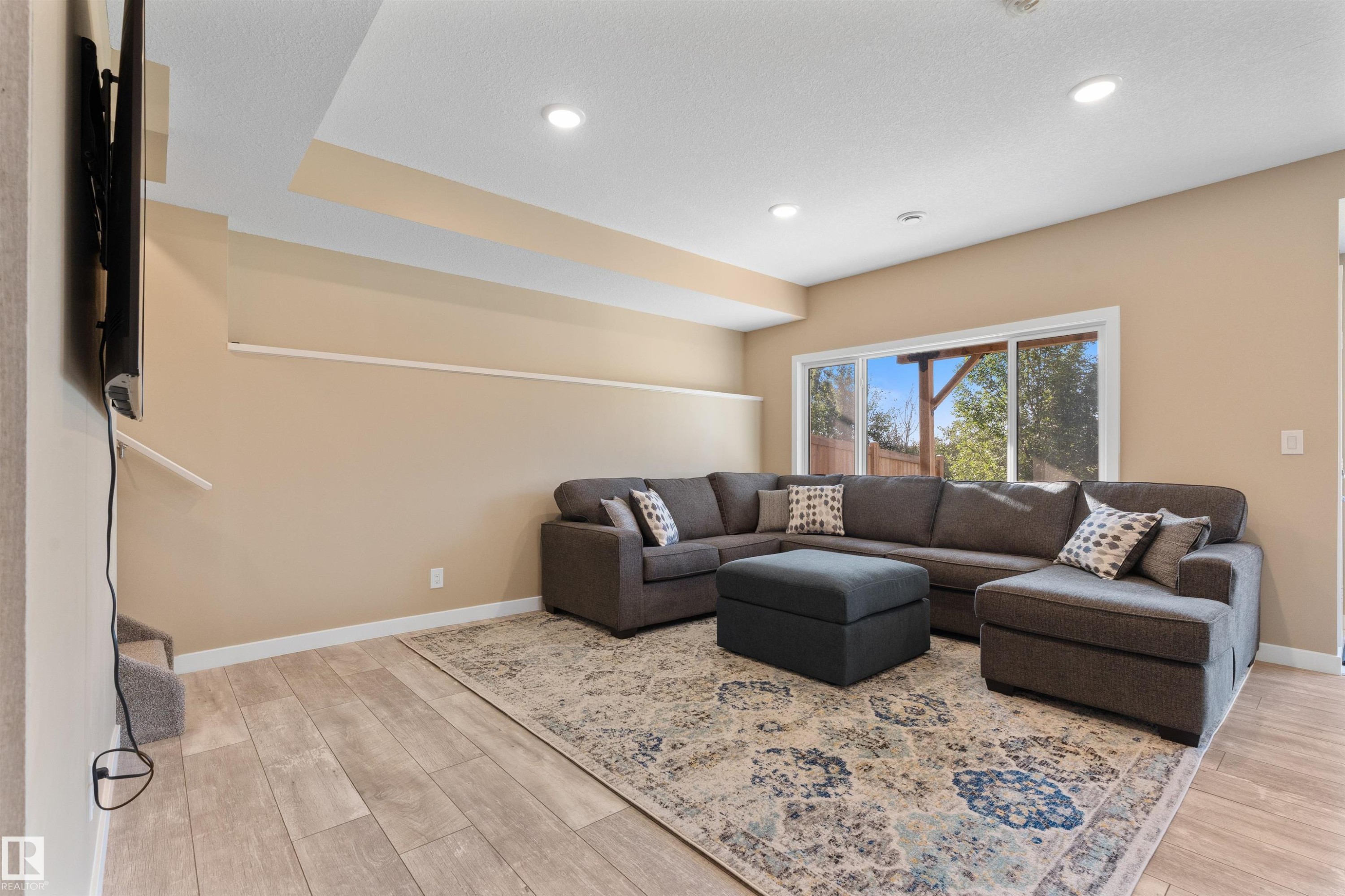 LED lighting, large window, wood-finish flooring, and neutral wall paint - 3334 Parker Loop Sw, Edmonton, AB