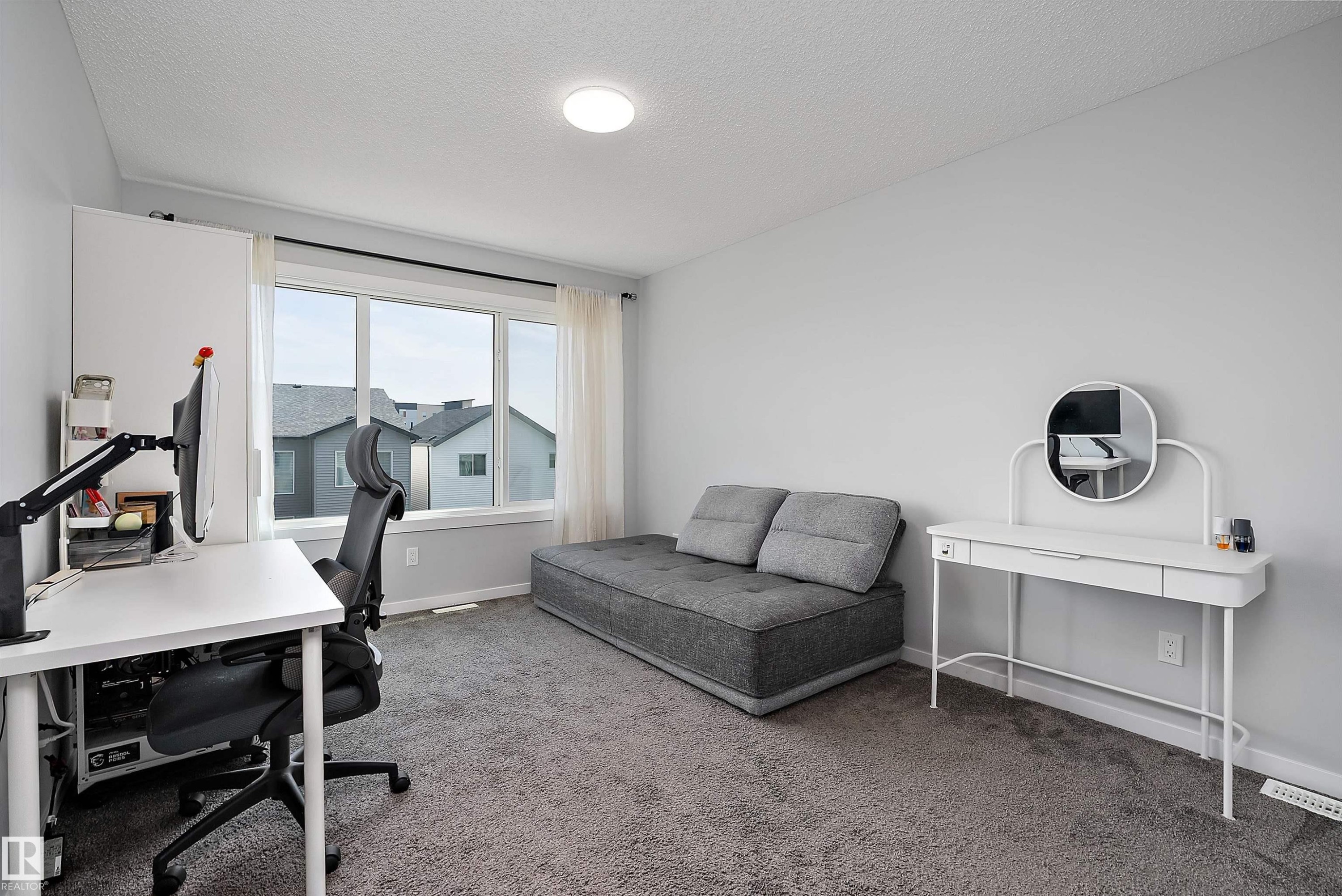 Neutral-toned wall finish, recessed ceiling lighting, multi-panel window, and carpeting - 9227 223 Street Nw, Edmonton, AB