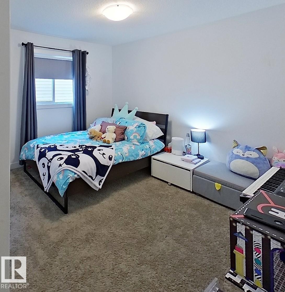 Carpeted flooring, white walls, window with roller blind, dark-toned curtain rod, and a flush mount ceiling light - 40 Jamison Crescent, St. Albert, AB