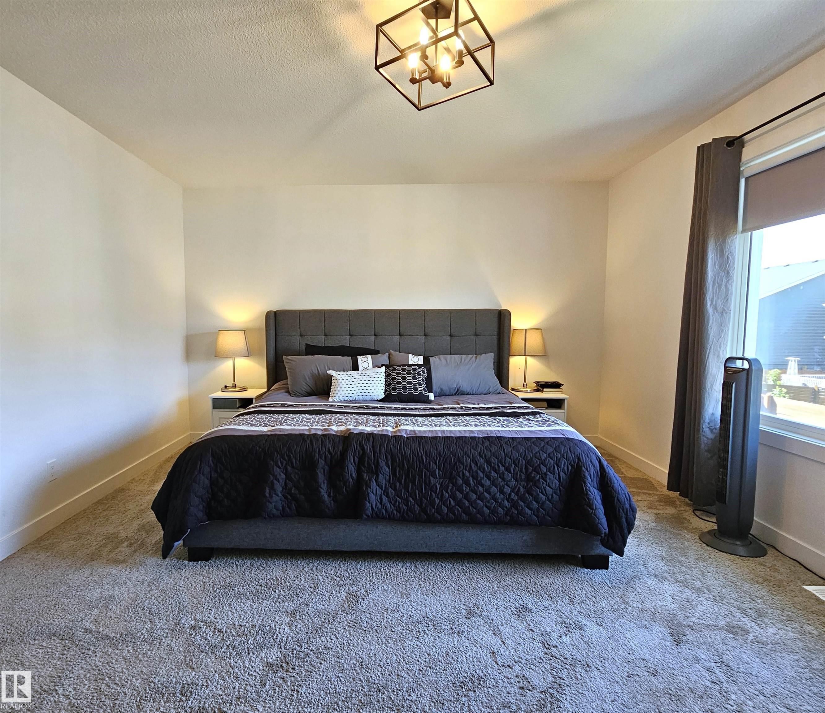 Recessed lighting, wall-to-wall carpeting, and a window with roller shade - 40 Jamison Crescent, St. Albert, AB