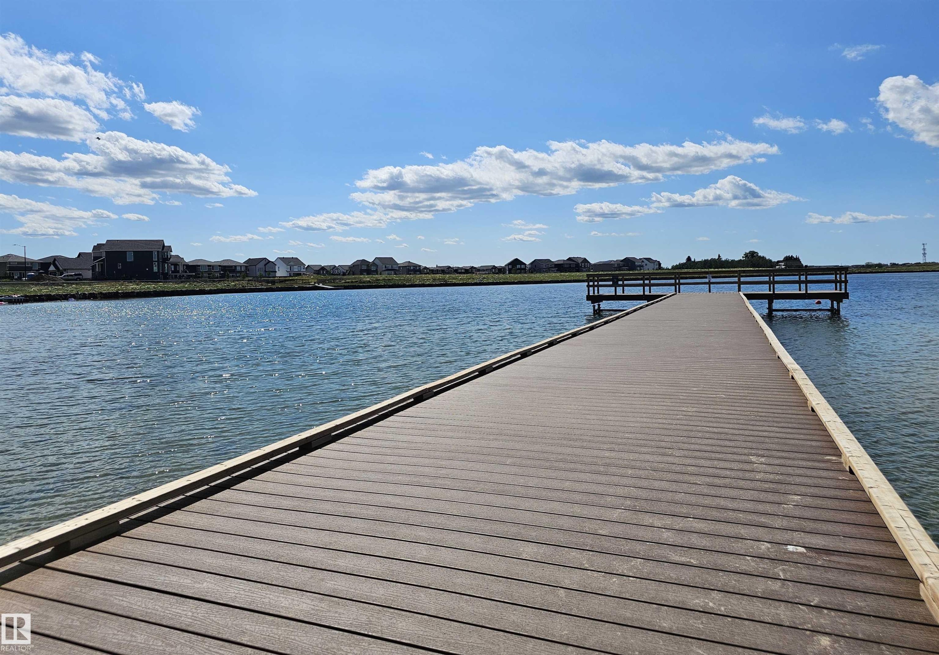 Waterfront property featuring a composite deck pier, access to a body of water, and surrounding residential structures - 40 Jamison Crescent, St. Albert, AB