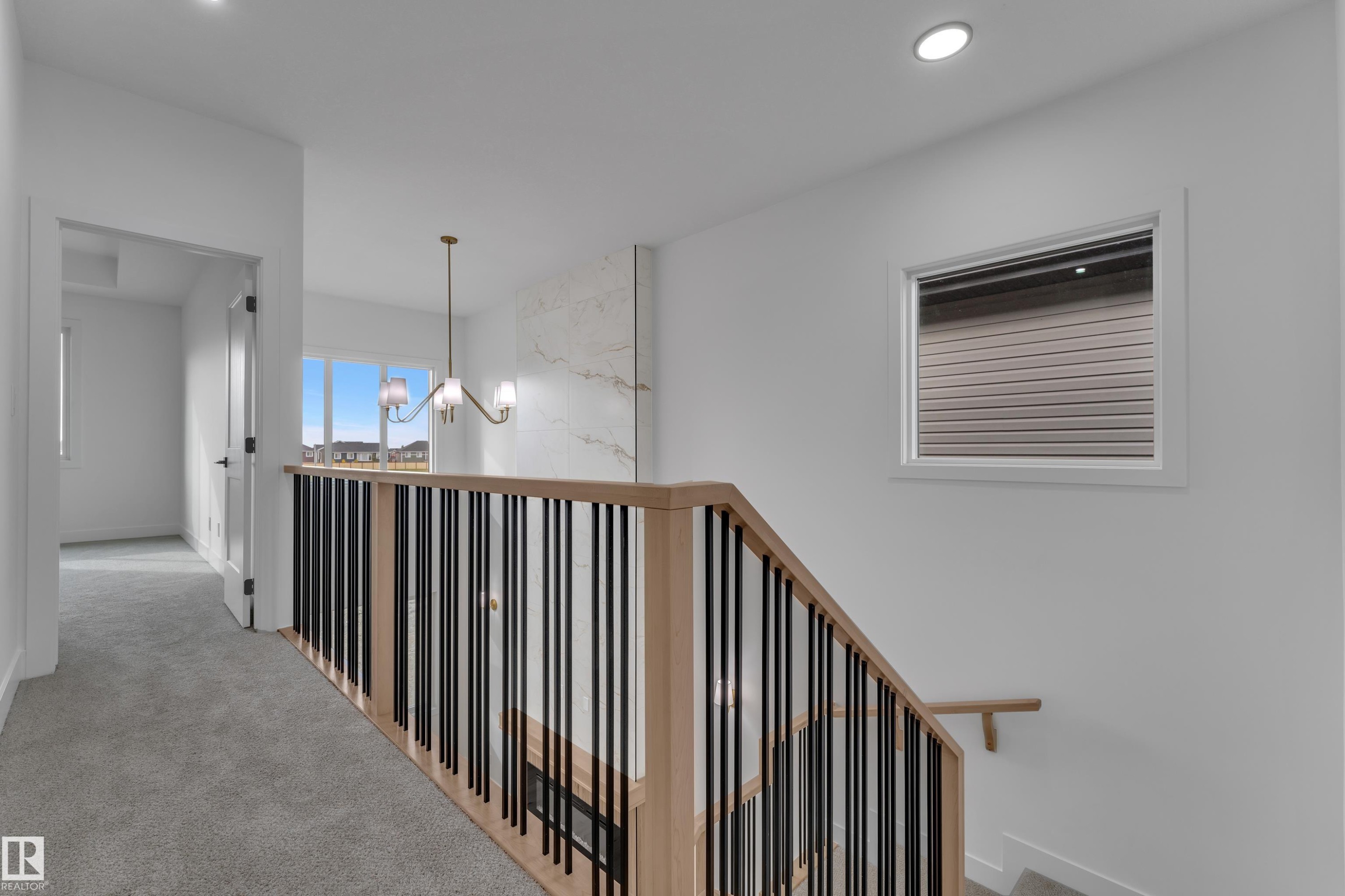 Upper-level hallway with gray carpet flooring and recessed lighting - 178 Munn Way, Leduc, AB