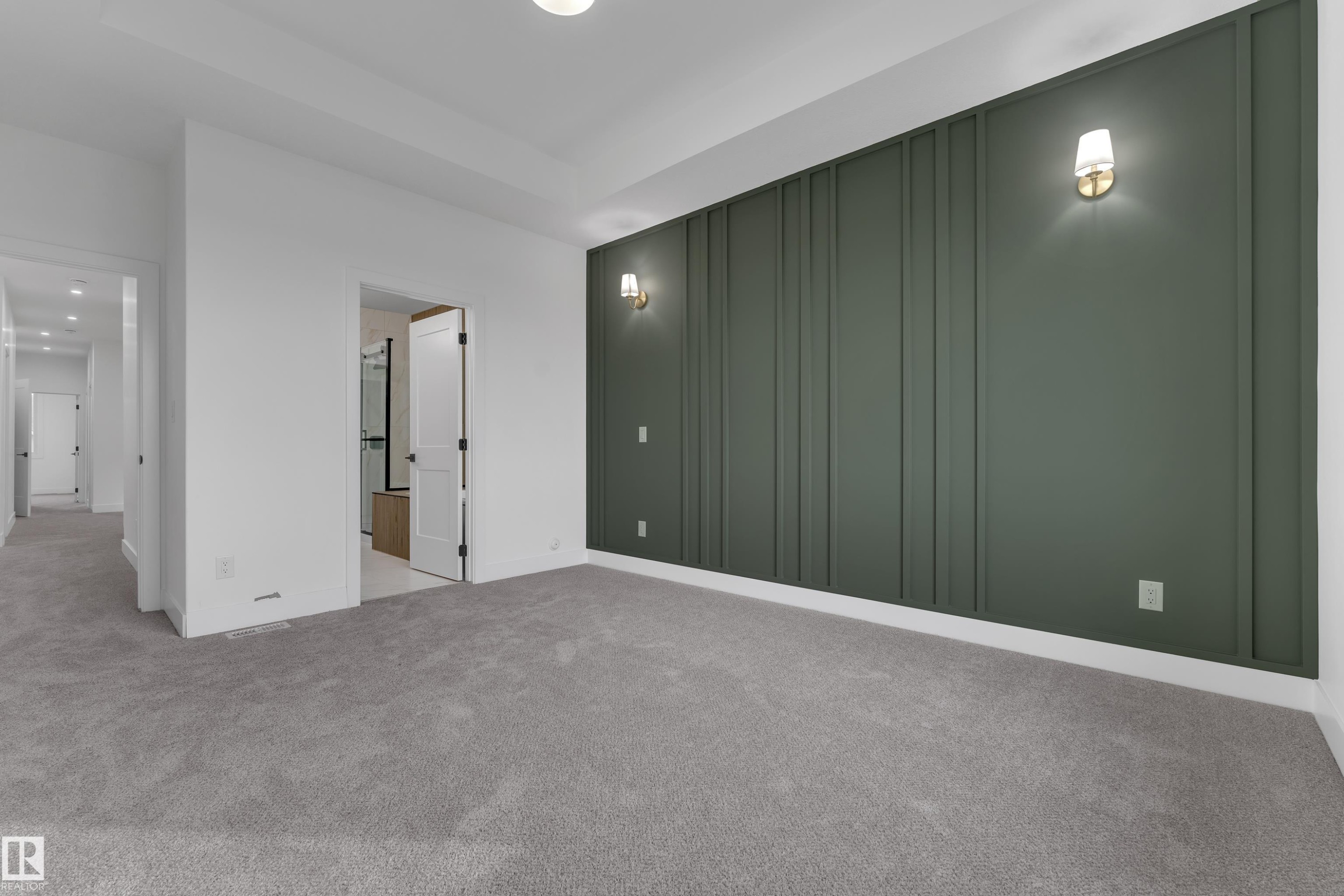 Carpeted flooring, recessed lighting, accent wall with vertical paneling, and wall sconces - 178 Munn Way, Leduc, AB
