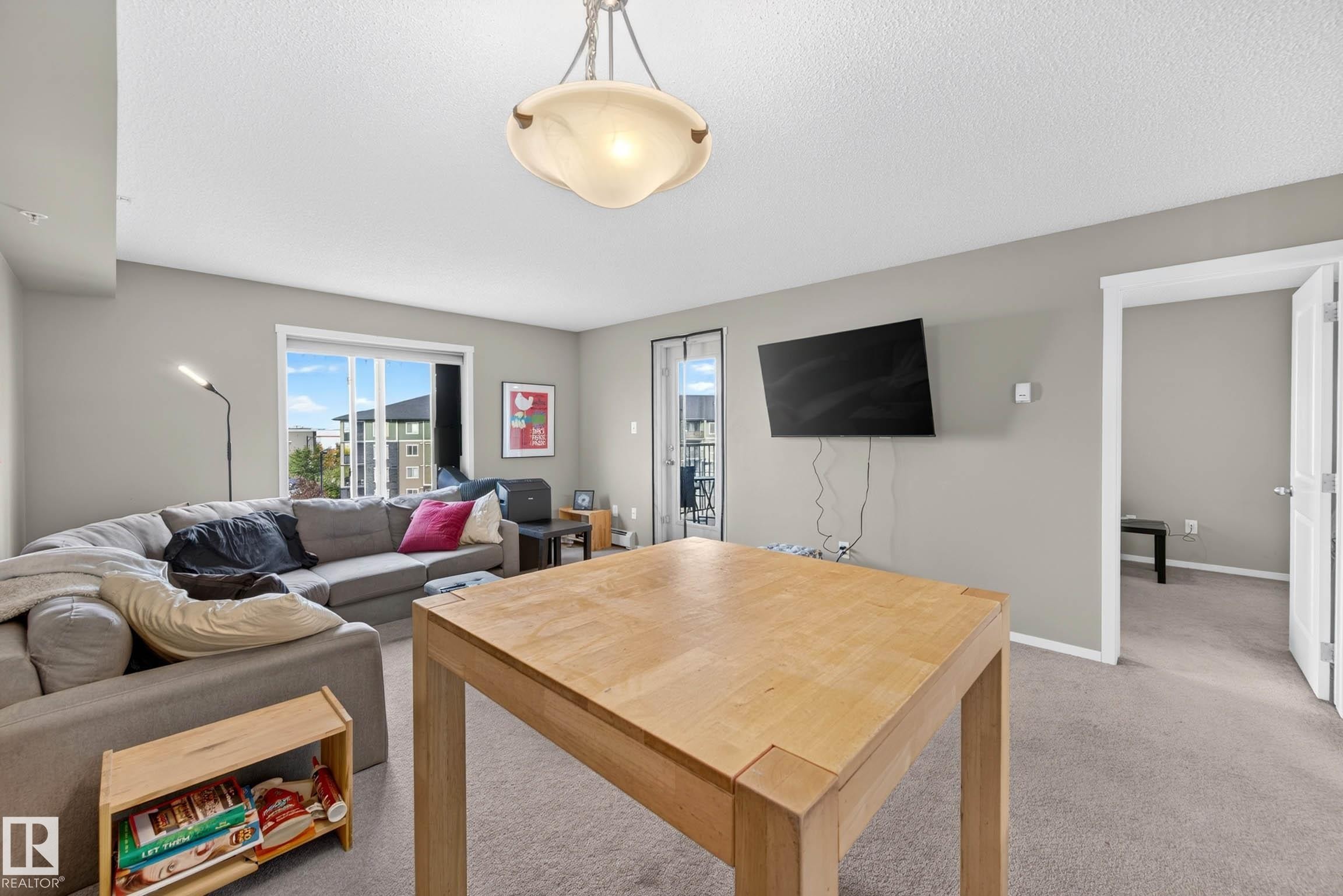Light gray wall paint, carpeting, and a built-in ceiling light fixture - #408 25 Element Dr, St. Albert, AB
