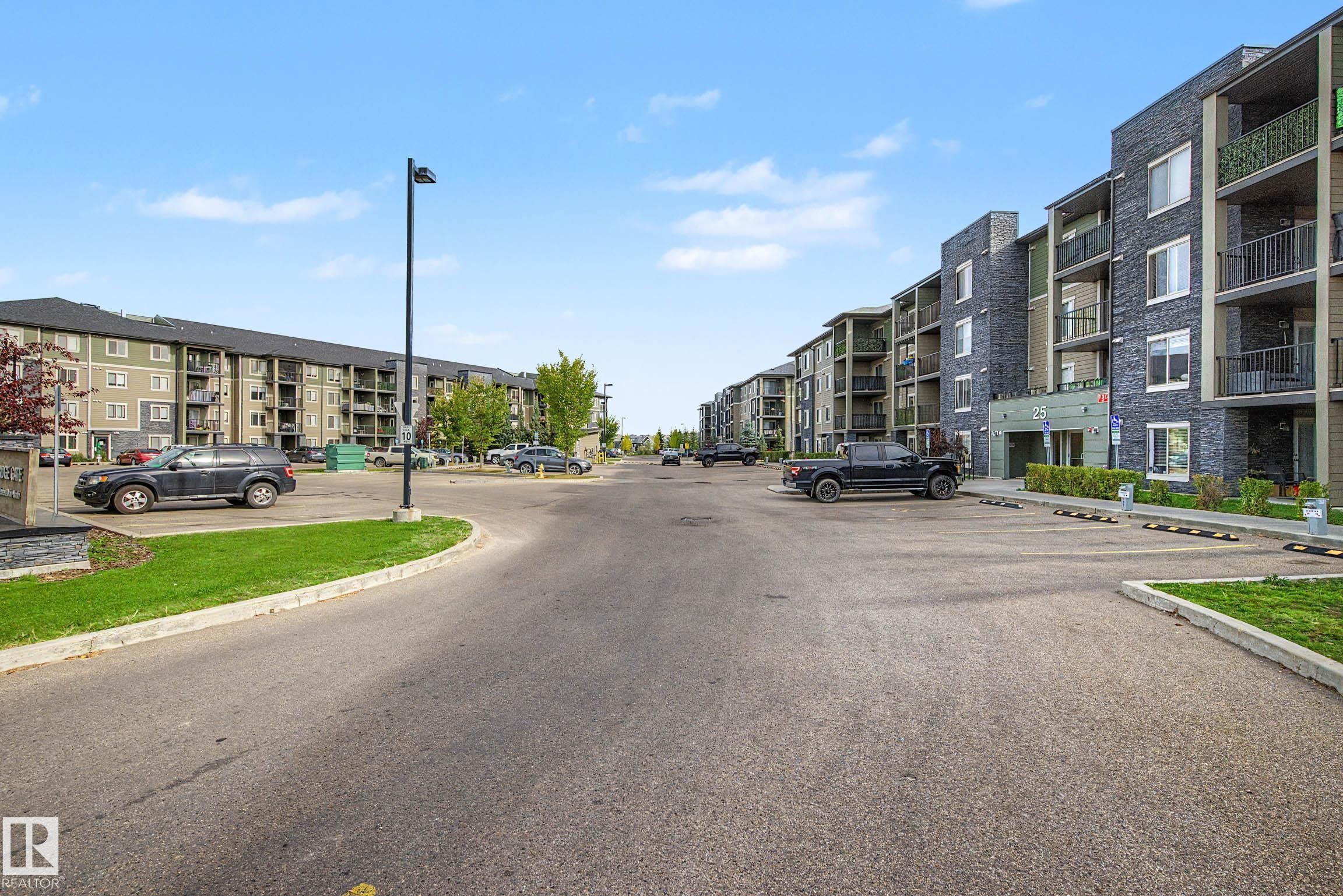 Multi-level residential buildings featuring dark brick and light siding exteriors - #408 25 Element Dr, St. Albert, AB