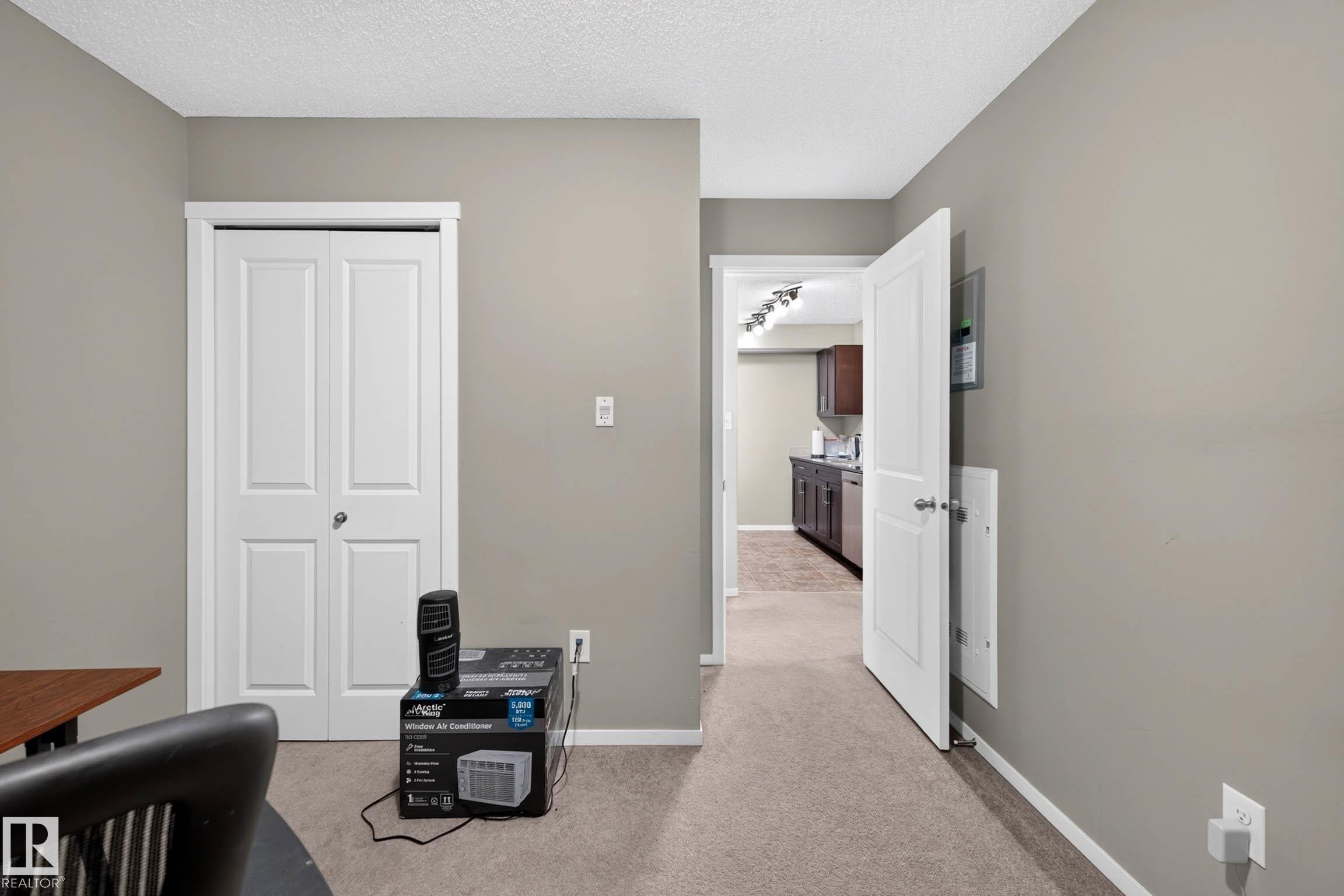 Neutral wall paint, carpet flooring, bi-fold closet doors, and recessed lighting in the background - #408 25 Element Dr, St. Albert, AB
