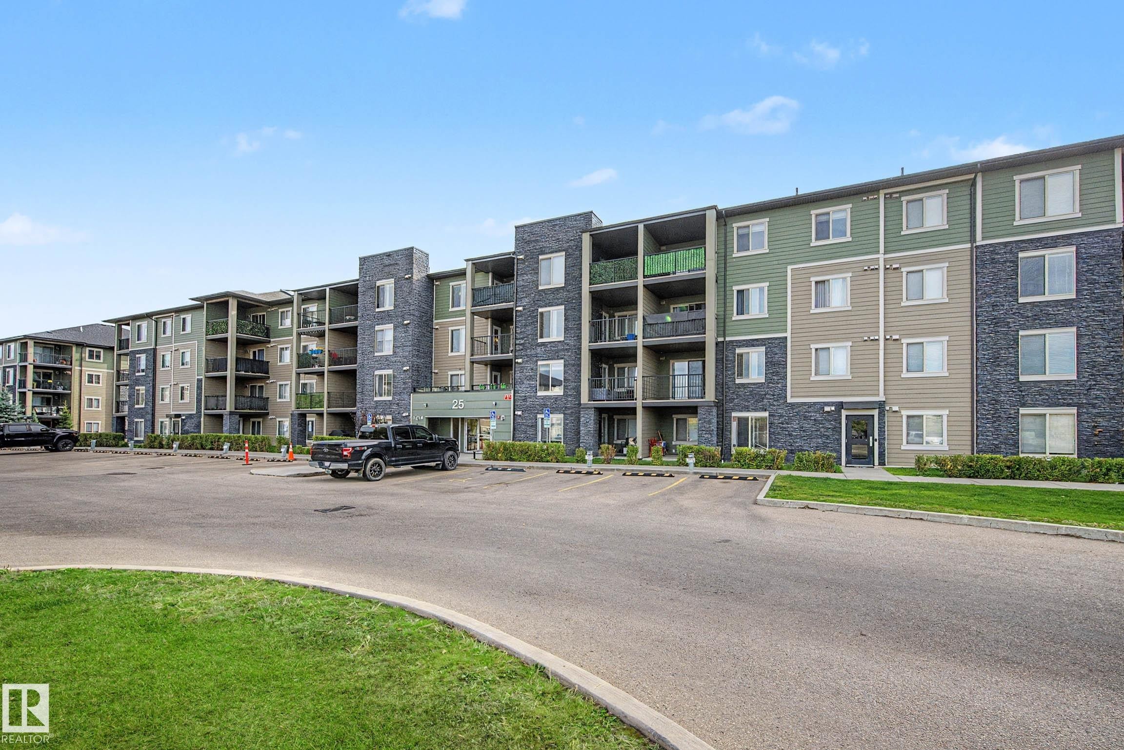 Multi-story building featuring balconies, stone veneer accents, and exterior siding - #408 25 Element Dr, St. Albert, AB