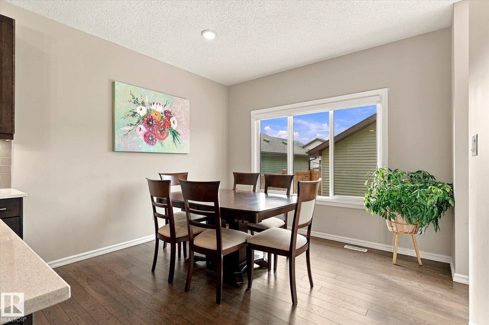 Recessed ceiling lighting, wood-finish flooring, white trim, and a large window - 21935 91 Avenue Nw, Edmonton, AB