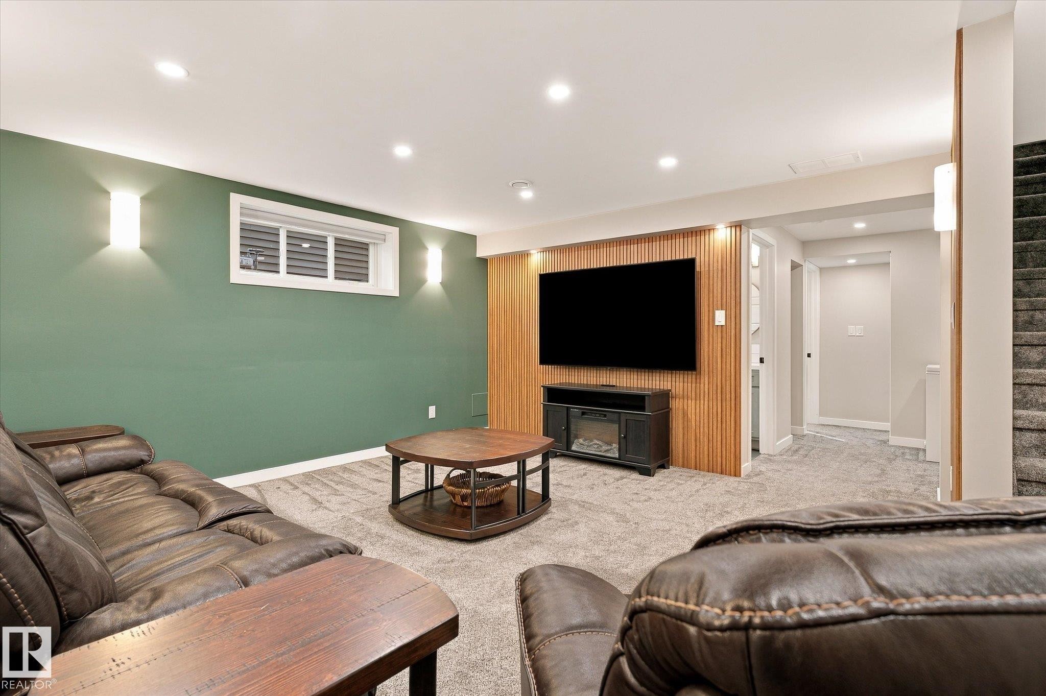 Recessed lighting, wall sconces, wood panel accent wall, window with blinds, and carpeted flooring - 21935 91 Avenue Nw, Edmonton, AB