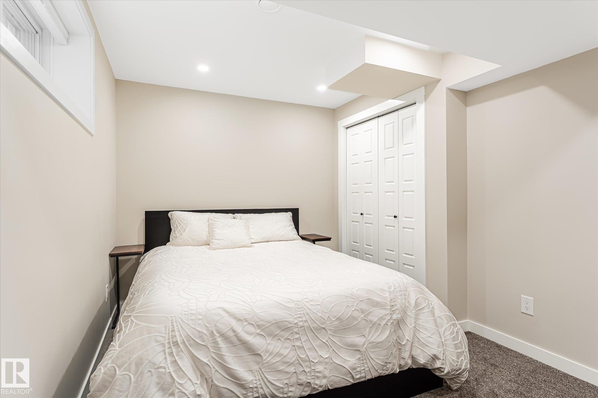 Recessed lighting, neutral wall paint, bi-fold closet doors, carpeting, and a window - 21935 91 Avenue Nw, Edmonton, AB