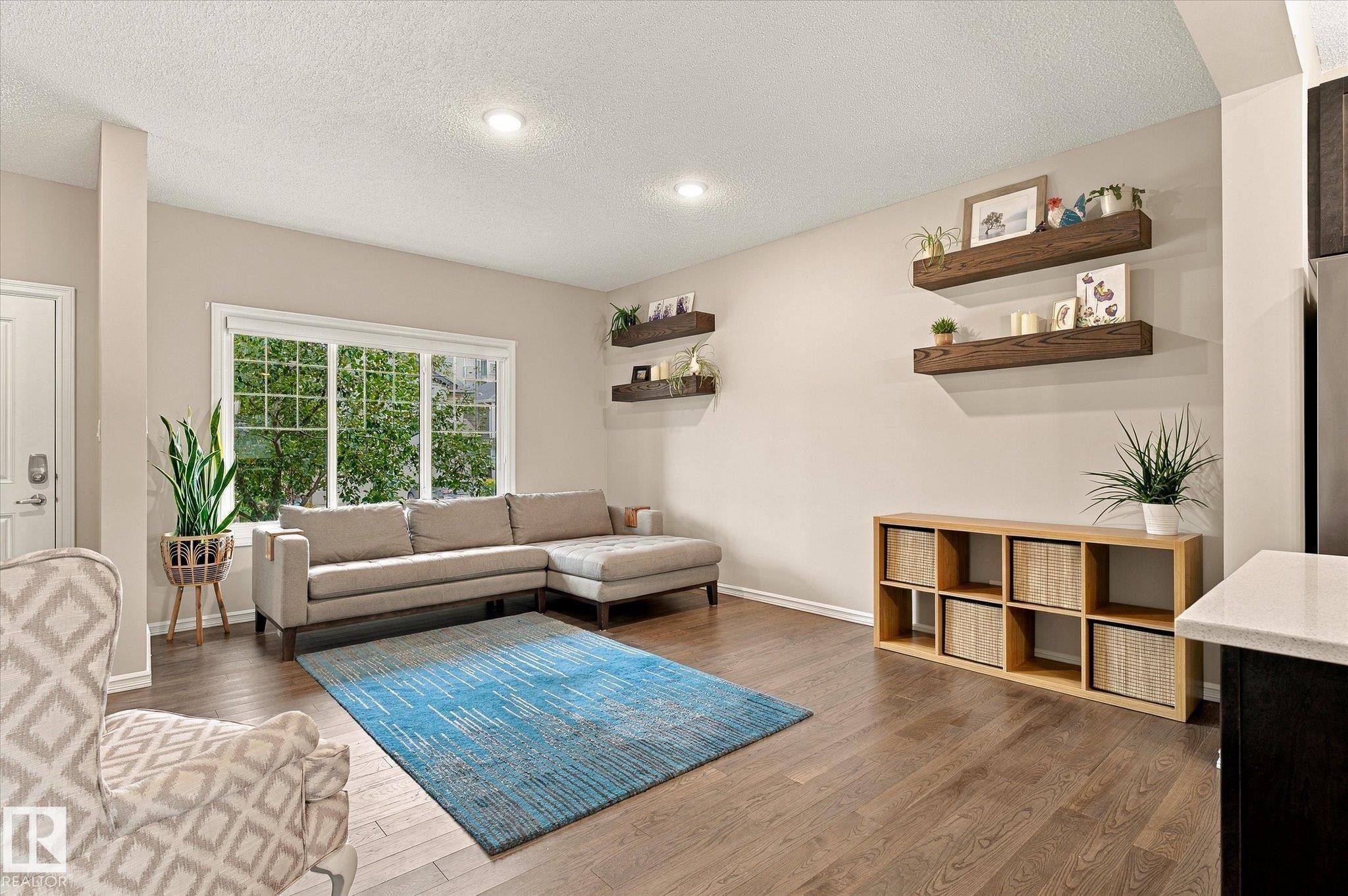 Recessed lighting, wood-finish flooring, white trim, and built-in floating shelves - 21935 91 Avenue Nw, Edmonton, AB