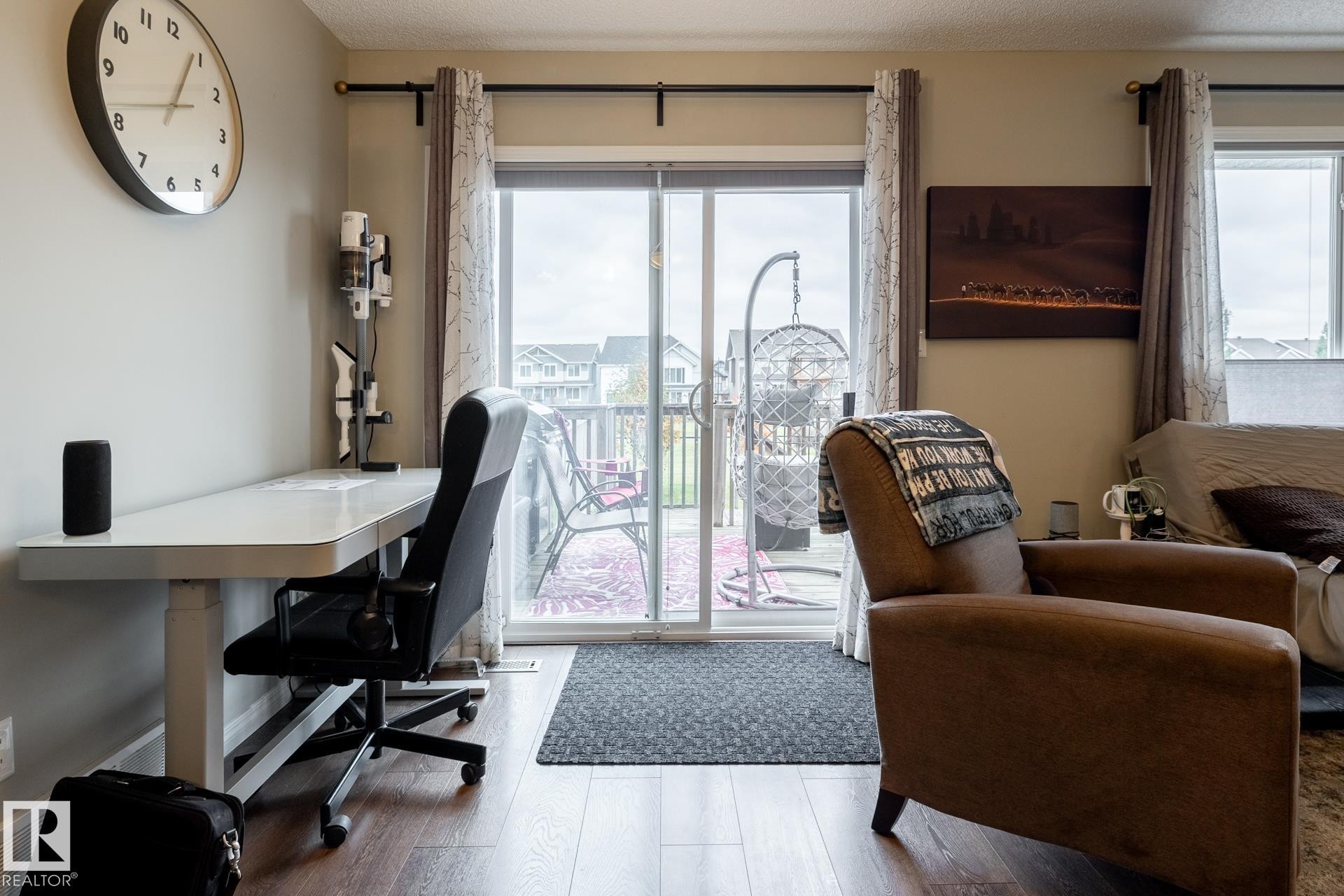 Sliding glass door with horizontal blinds and wood-finish flooring - 2093 Chalmers Way Sw, Edmonton, AB