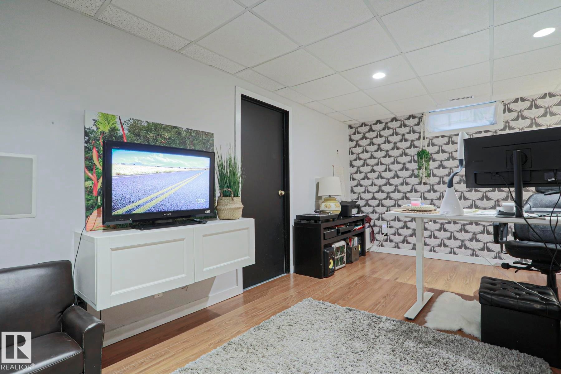 Recessed lighting illuminates wood-finish flooring - 5 Gilmore Crescent, St. Albert, AB