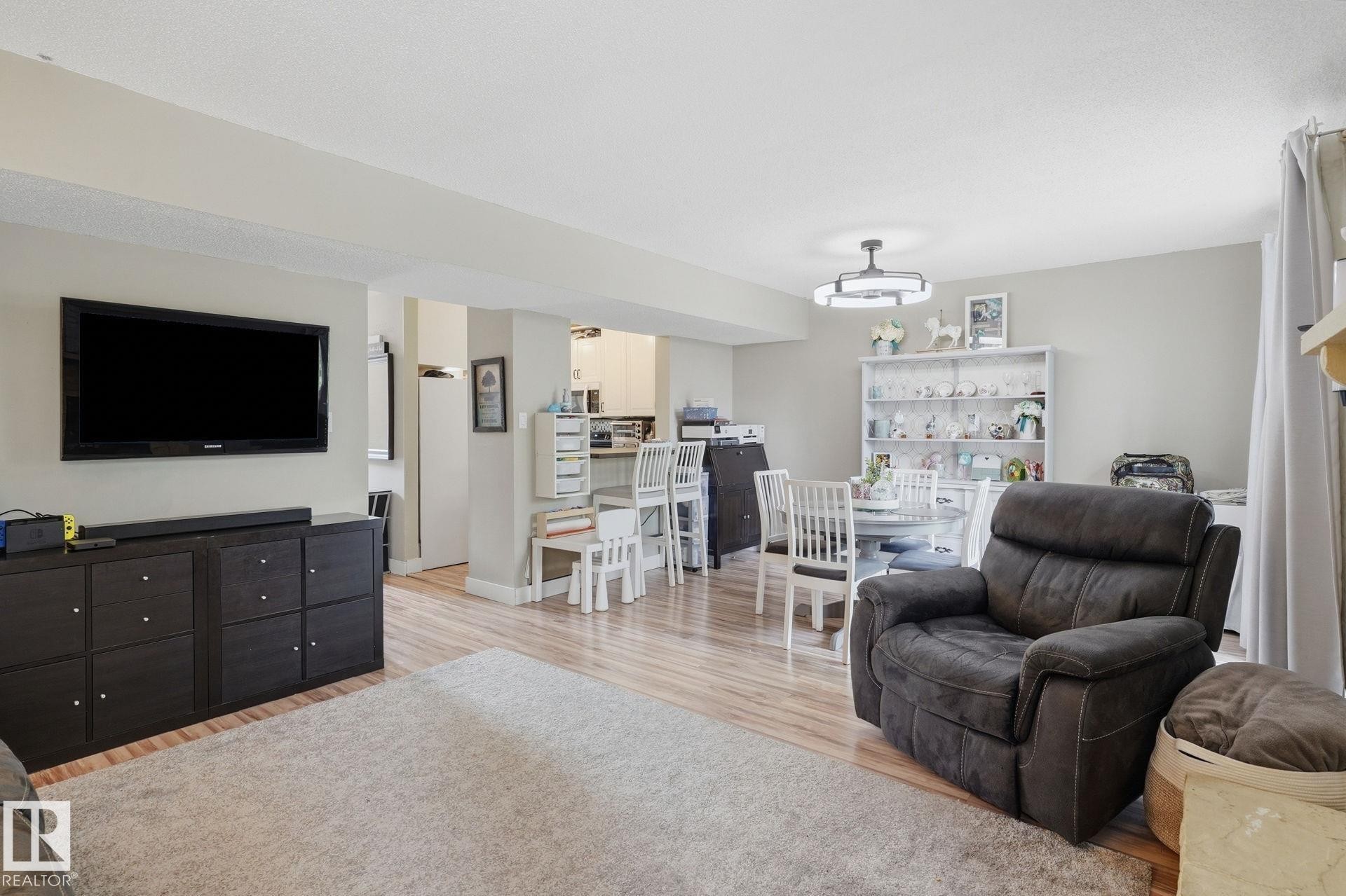 Wood-finish flooring throughout, light neutral wall tones, and recessed lighting - 5340 38A Avenue Nw, Edmonton, AB