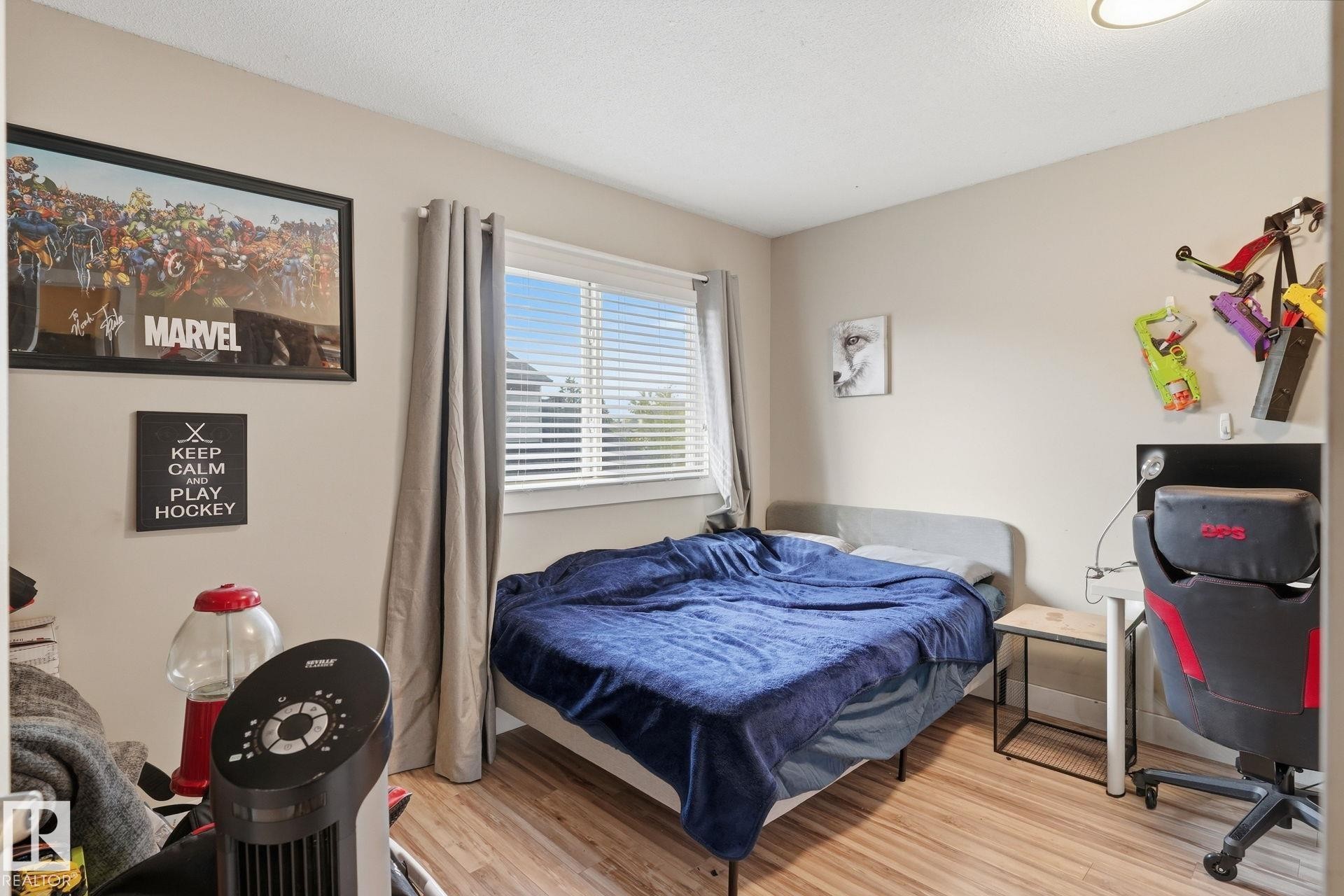 Wood-finish flooring with neutral wall tones - 5340 38A Avenue Nw, Edmonton, AB