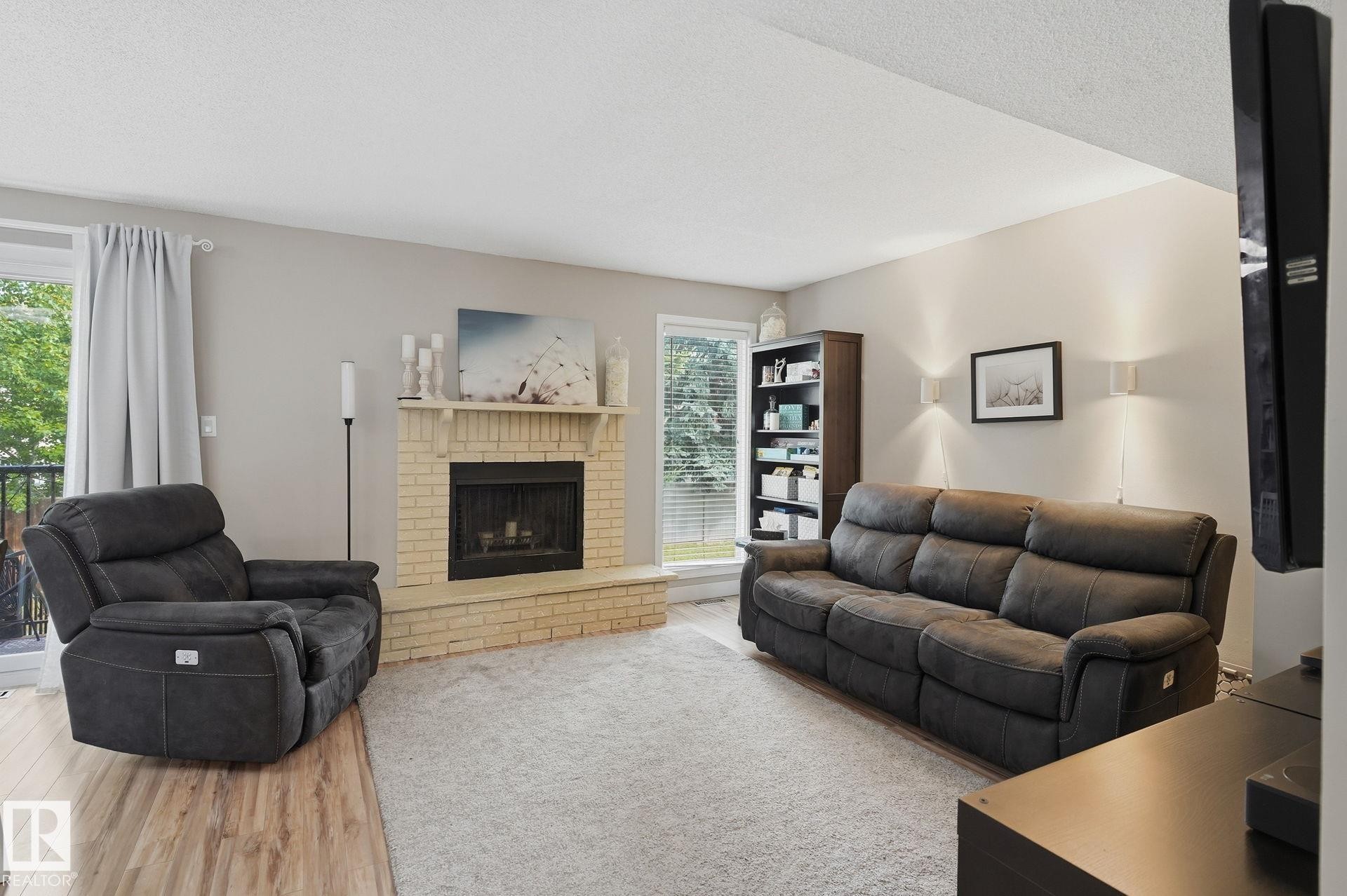 Brick-faced fireplace with a mantel, light gray walls, and recessed lighting - 5340 38A Avenue Nw, Edmonton, AB