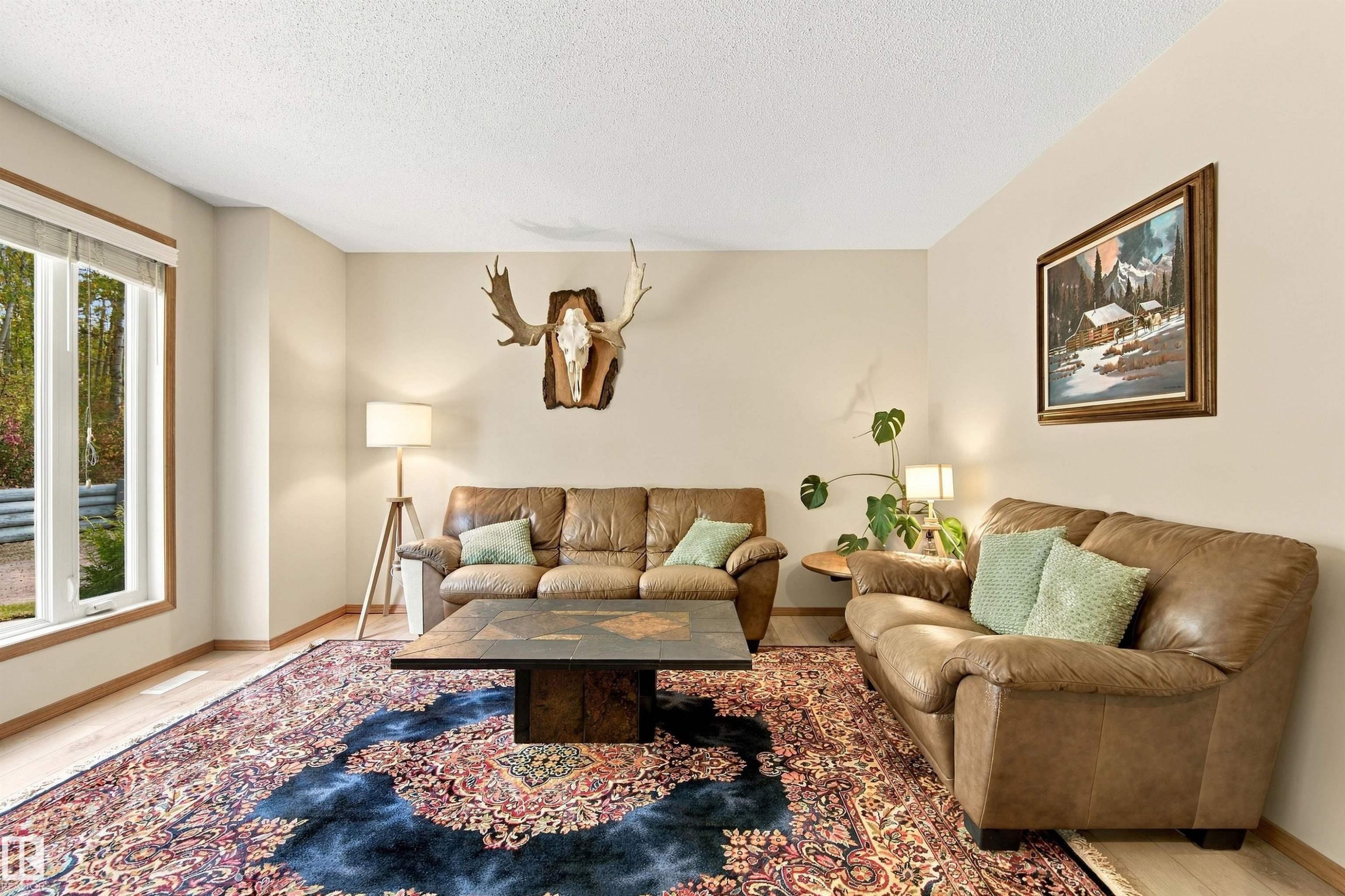 Recessed lighting, wood-finish flooring, and a large window with white trim - 51064 Rge Rd 222, Rural Strathcona County, AB