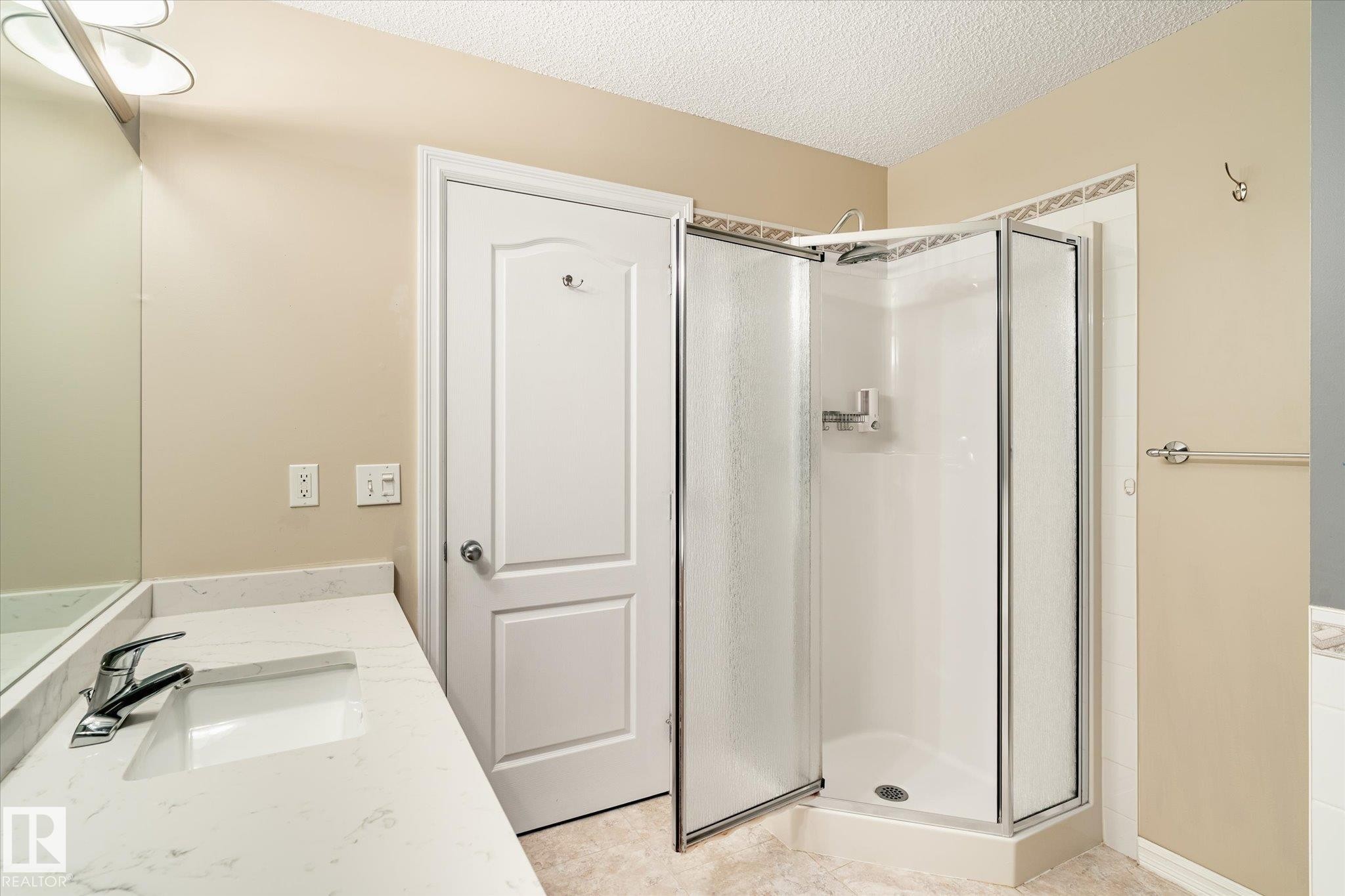 White countertop with integrated rectangular sink and chrome faucet - 2550 Rabbit Hill Road Nw, Edmonton, AB